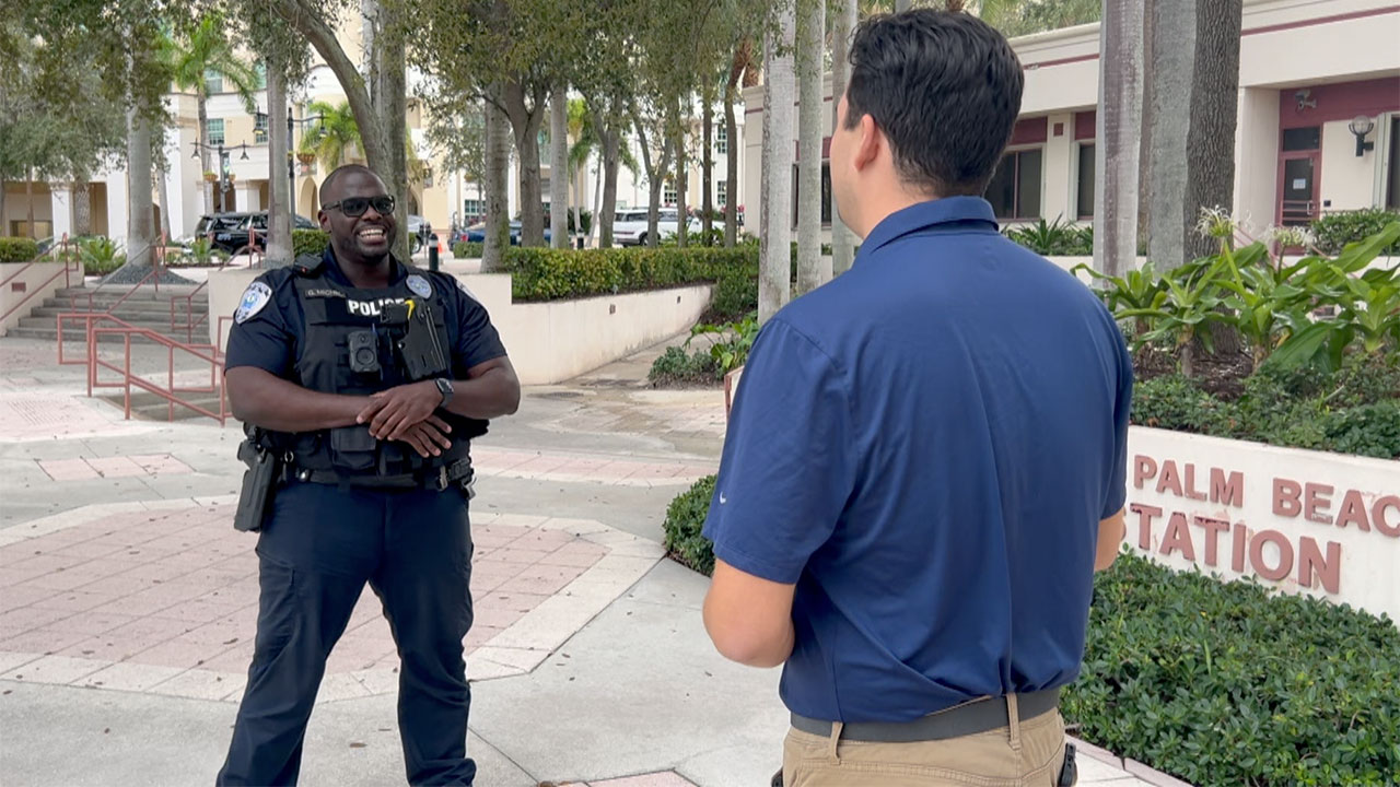Officer Gesner Michel speaks with WPTV reporter Michael Hoffman about his act of kindness.