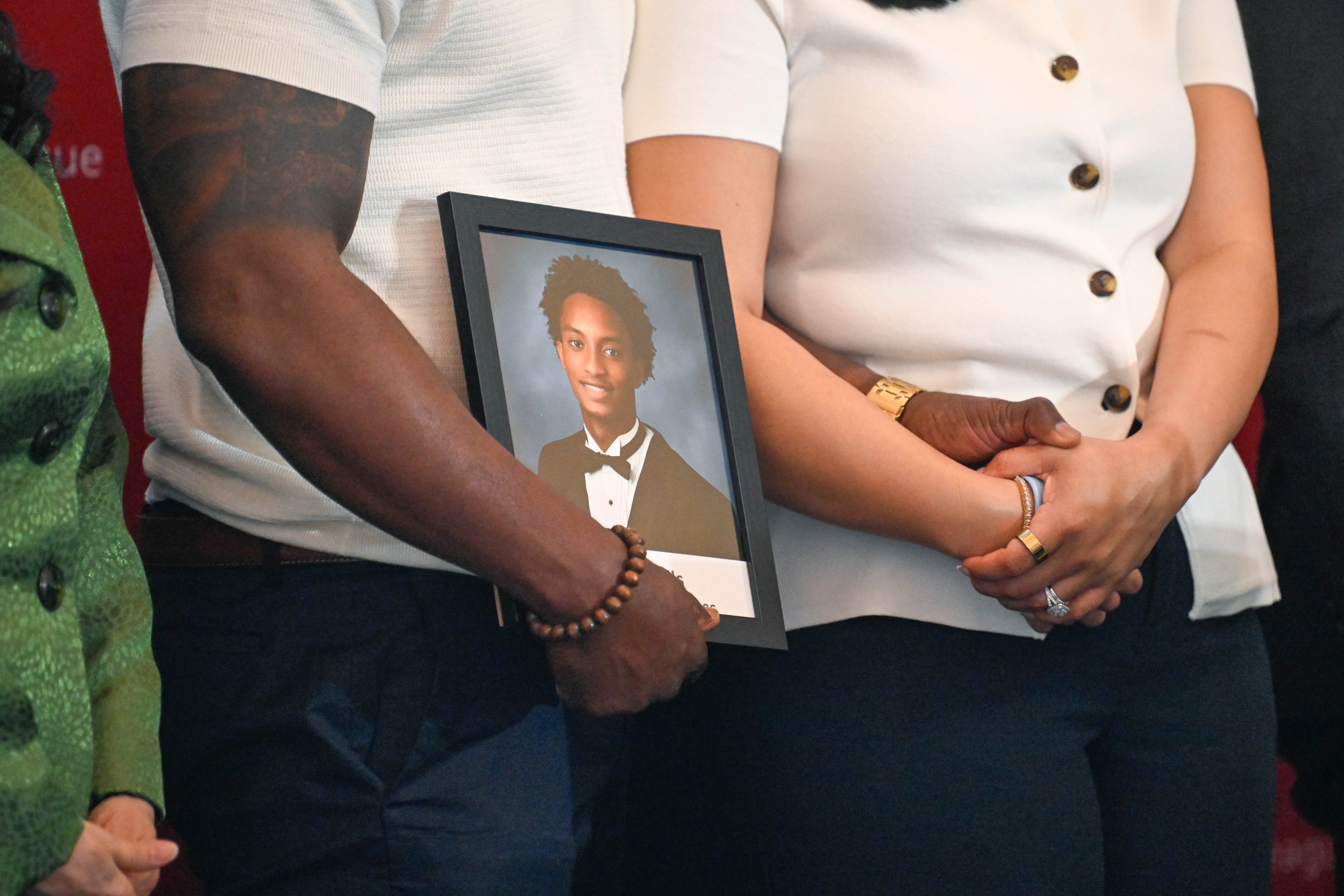 Christine Wonsley and Elmore Wonsley, mother and step father of Nolan Wells, stand on a stage with a photo of their son as they appear at the National Urban League's annual conference to share updates on his death, as well as Daniel Erving, and Tyler Smith, Thursday, July 30, 2026, in Nashville, Tenn. 