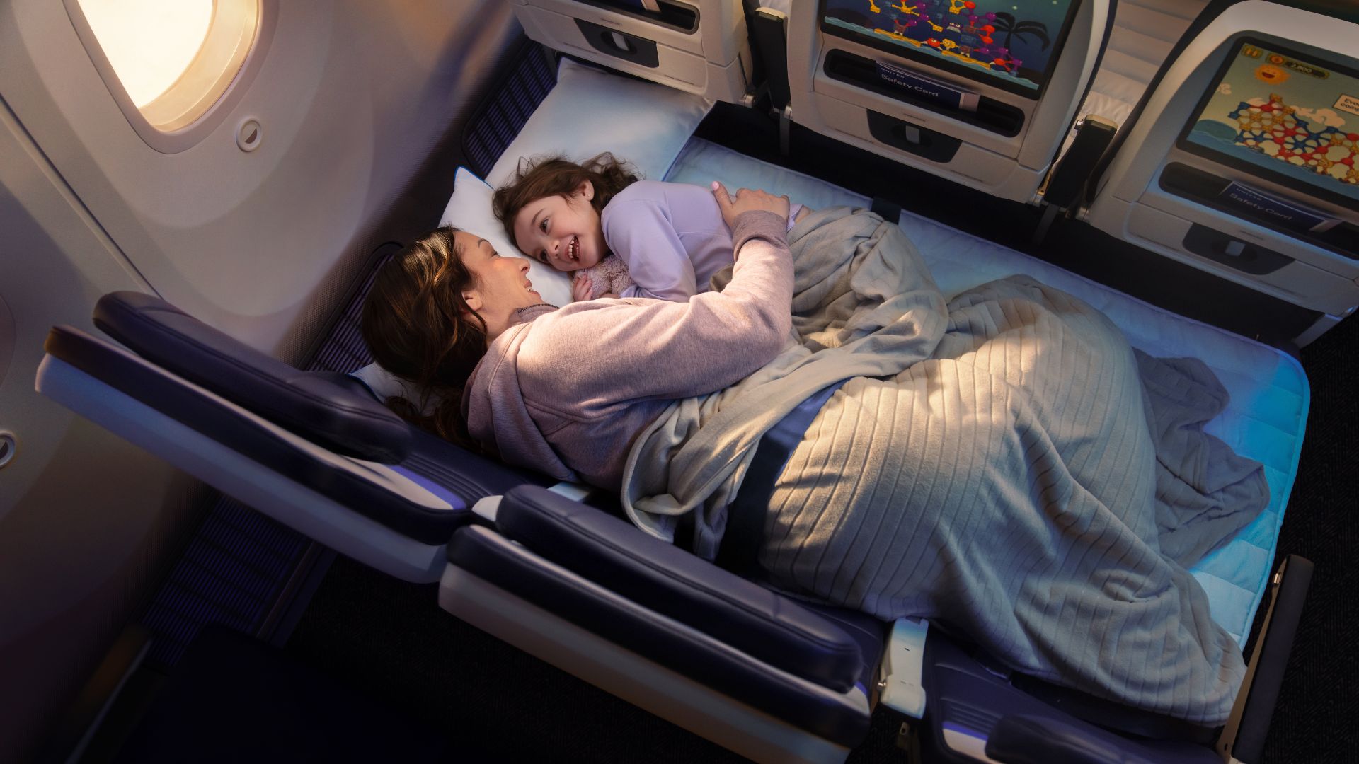 A woman and child lie down on a United Airlines flight.