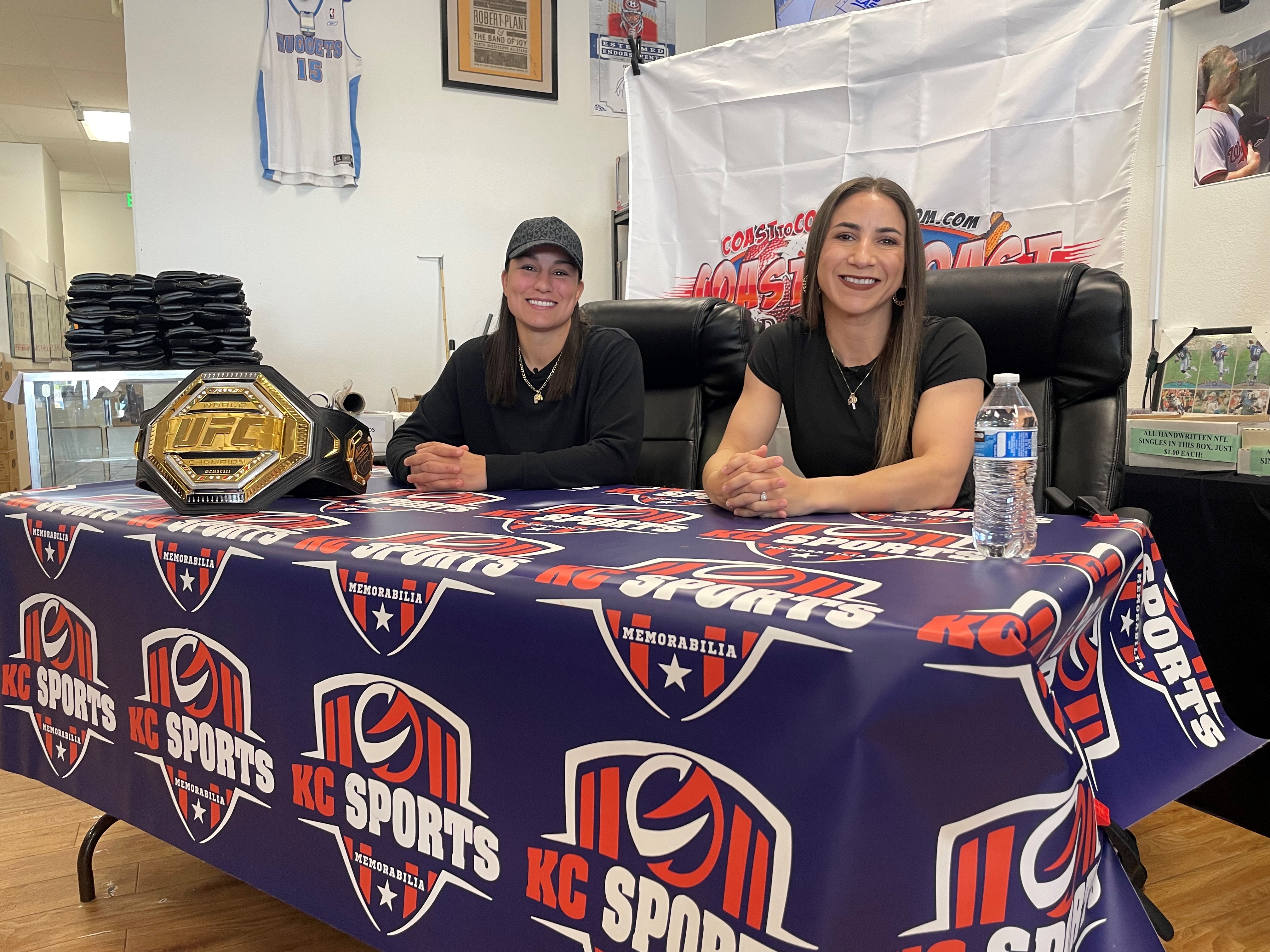UFC Women's bantamweight champion Raquel Pennington and her wife Tecia Torres stopped by an Aurora card shop to sign gear for fans.