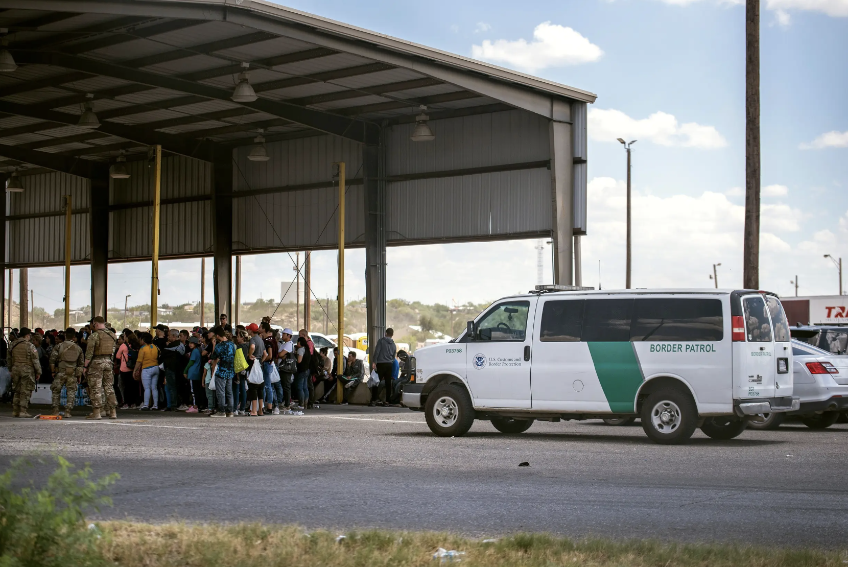 Migrants after crossing the Texas-Mexico border are brought to Eagle Pass on May 28, 2022