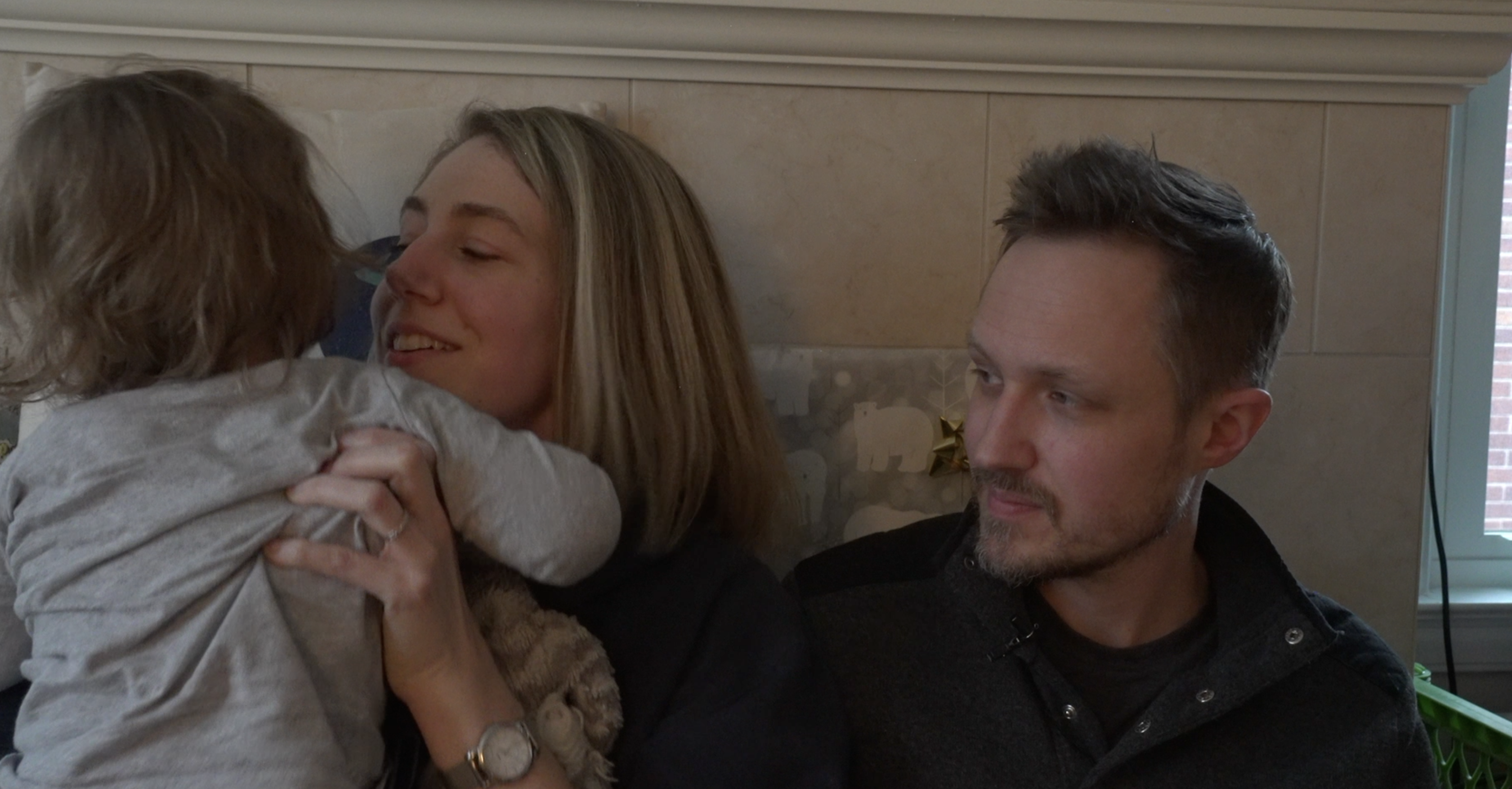 Erin Buitendorp and Paul Wozniak tending to their 2-year-old son