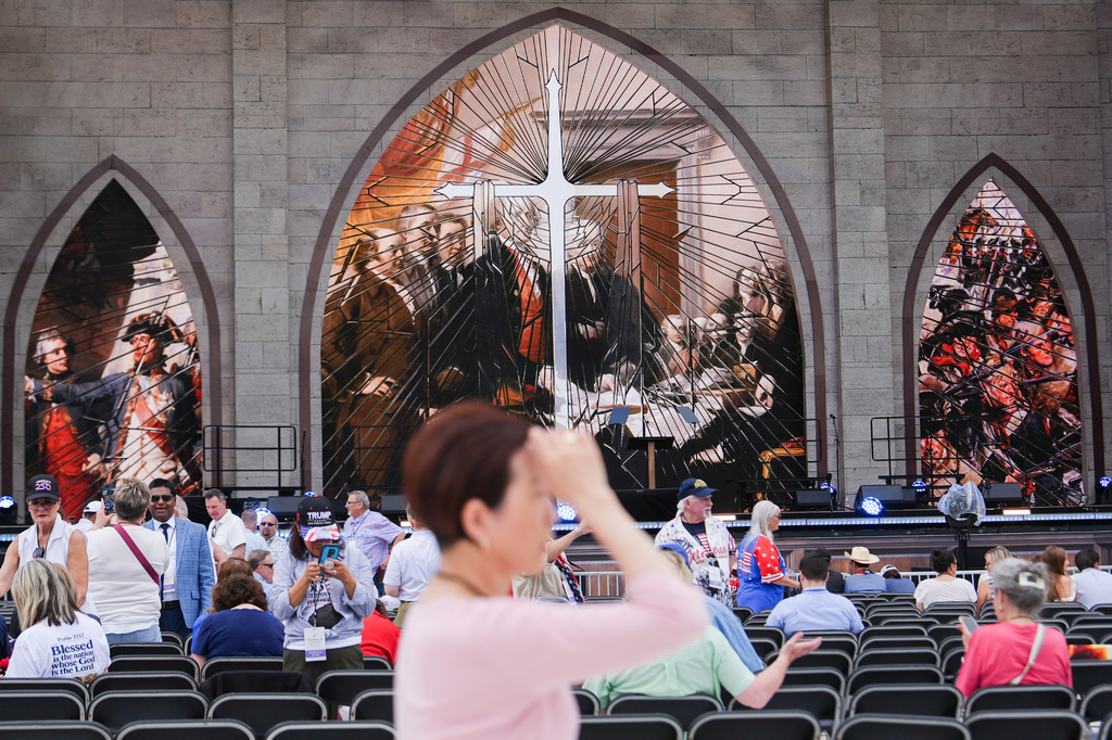 A person prays during Rededicate 250, a mostly conservative Christian prayer gathering in honor of the United States' 250th anniversary, on the National Mall, Sunday, May 17, 2026, in Washington.