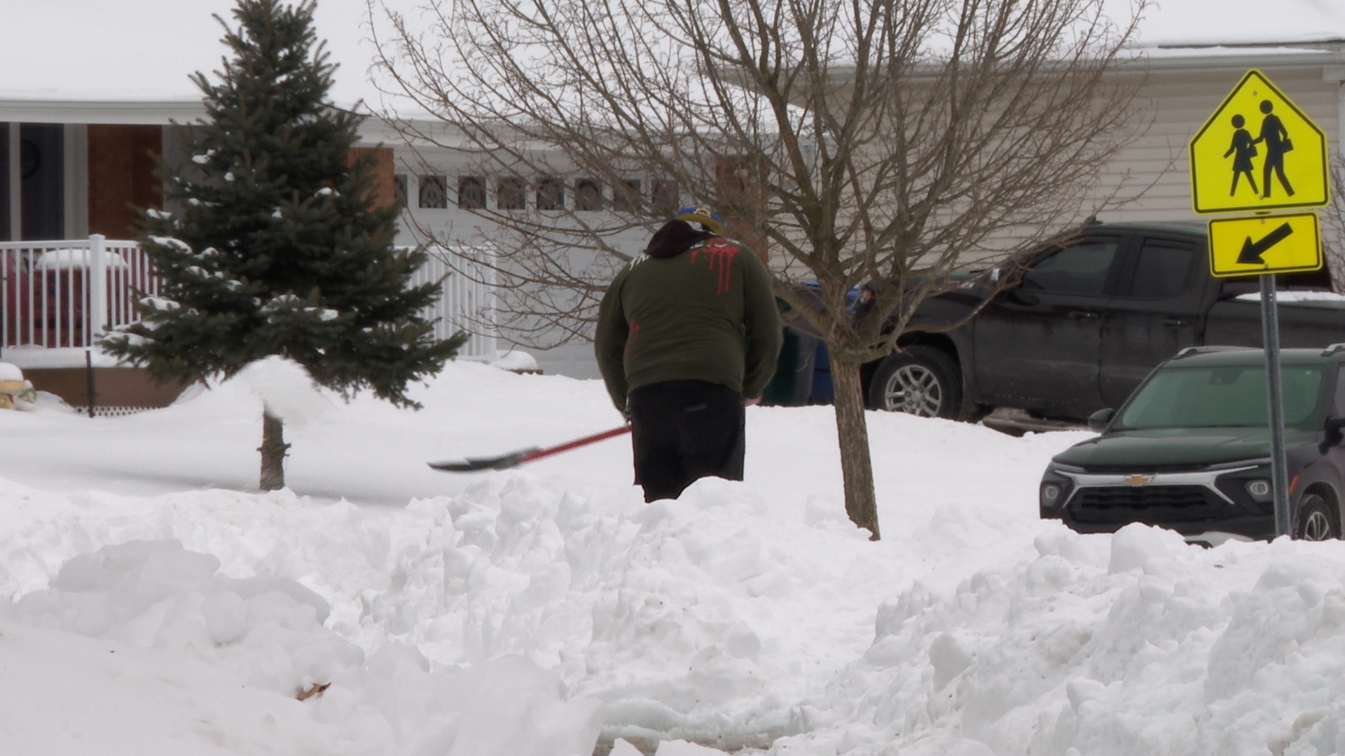 Guy shovels snow Lewton Elementary School