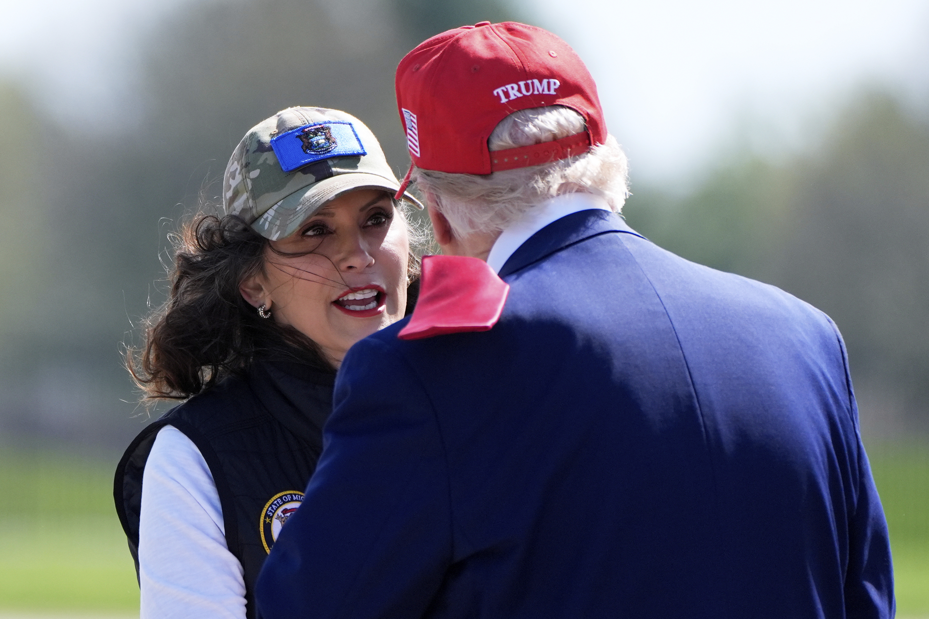 Michigan Gov. Gretchen Whitmer greets President Donald Trump as he arrives on Air Force One at Selfridge Air National Guard Base, Tuesday, April 29, 2025, in Harrison Township, Mich. 