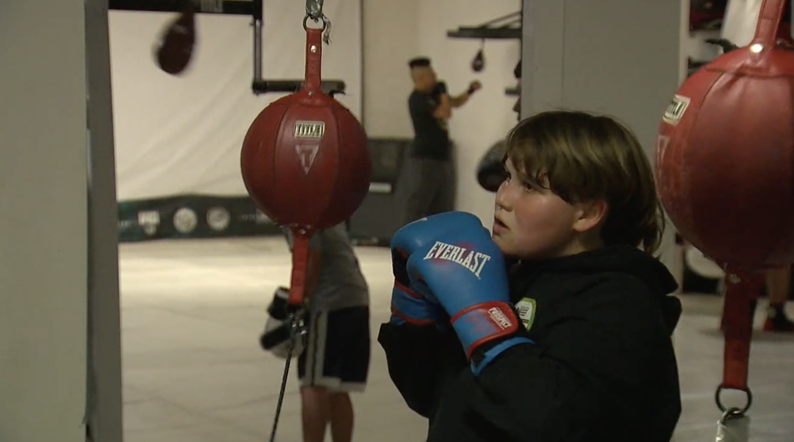 kid learning boxing techniques