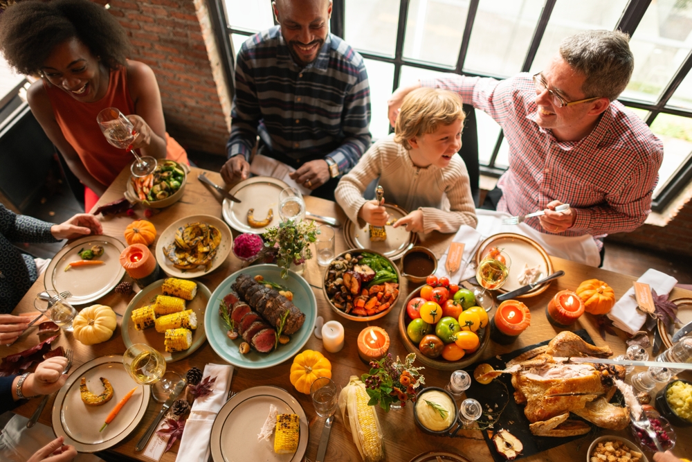 Stock image of people eating a Thanksgiving meal.