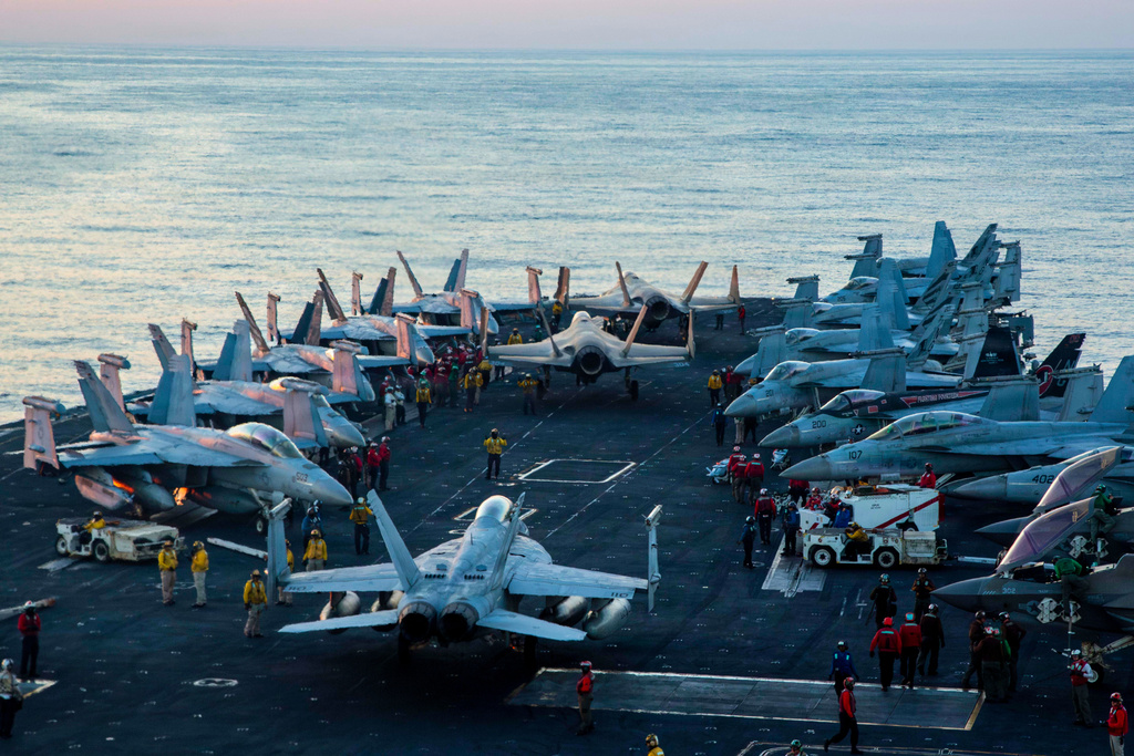 This image provided by U.S. Central Command shows Navy sailors taxiing aircraft to a staging point on the flight deck of the USS Abraham Lincoln (CVN 72) in support of Operation Epic Fury, on Saturday, Feb. 28, 2026.