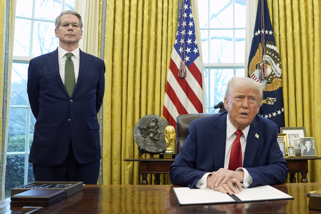 President Donald Trump speaks as Treasury Secretary Scott Bessent listens.