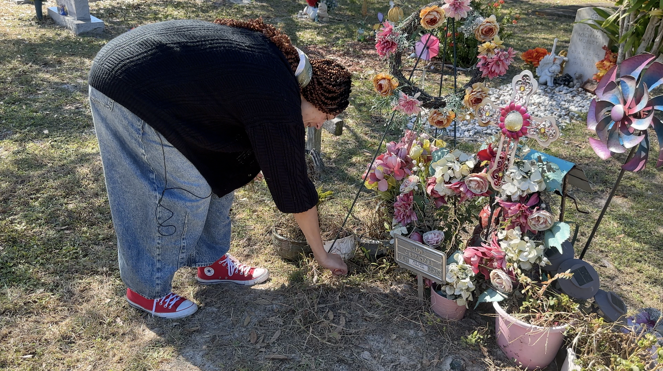 Williams cleaning a grave 