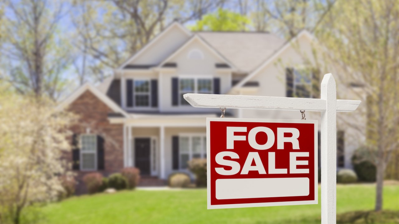 For sale sign in front of home.