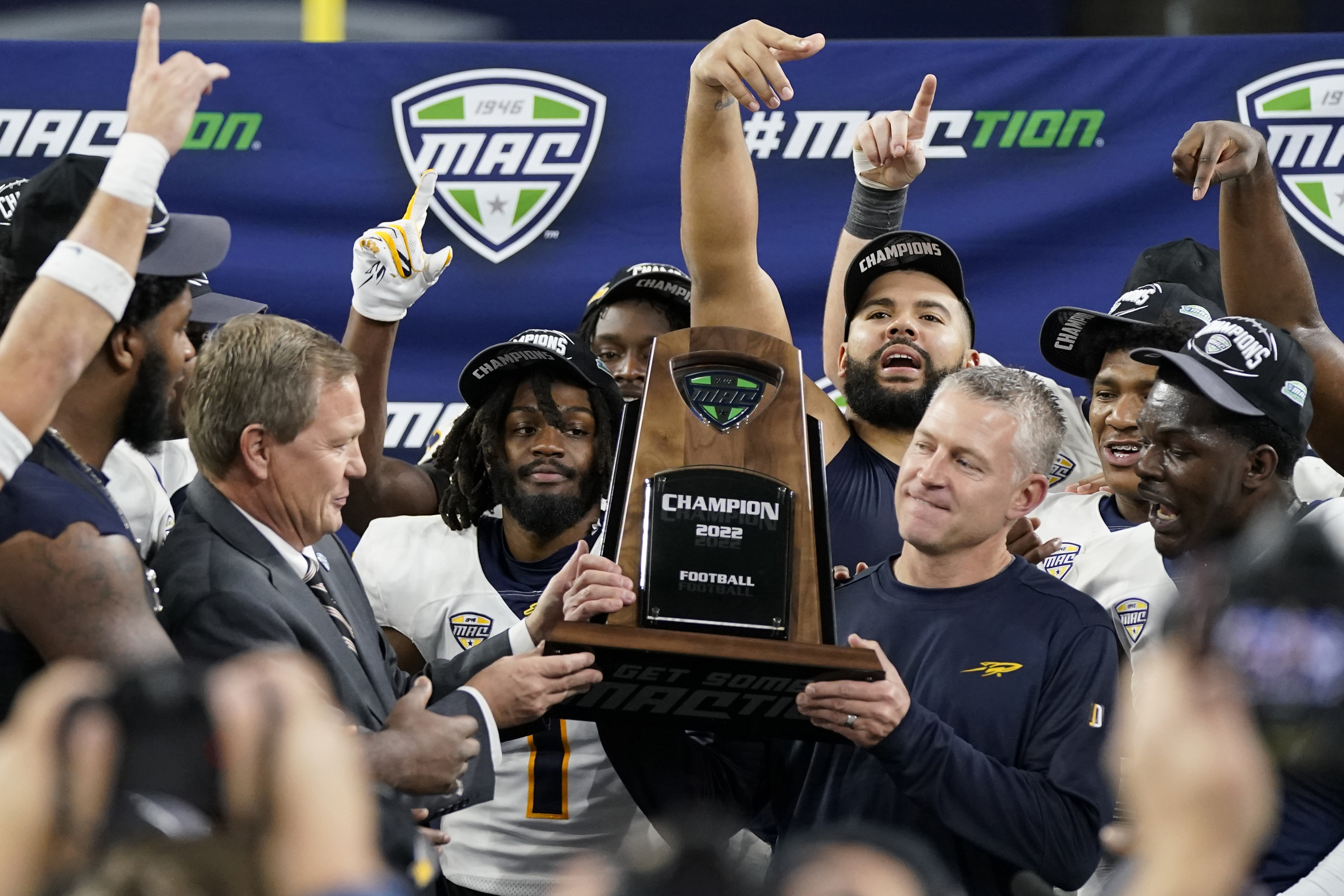 Toledo Rockets head coach Jason Candle holds 2022 MAC Championship trophy