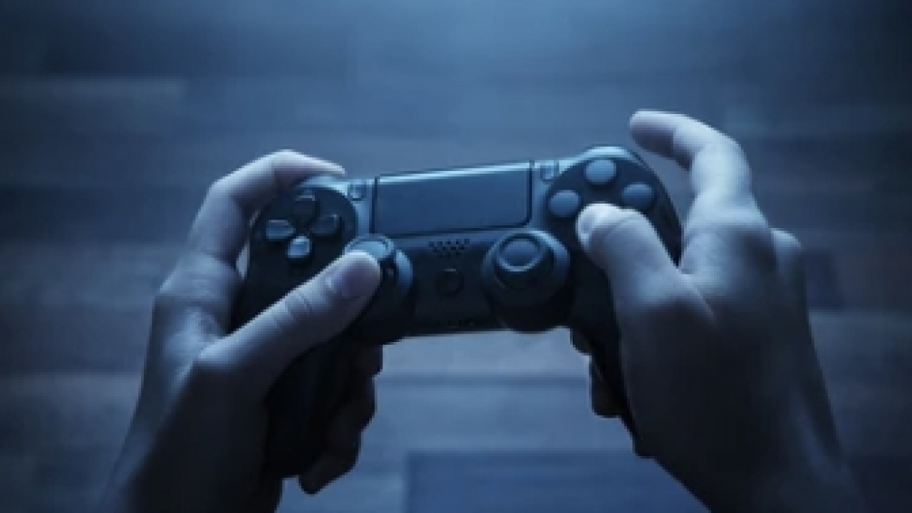 Person holding a gaming controller.