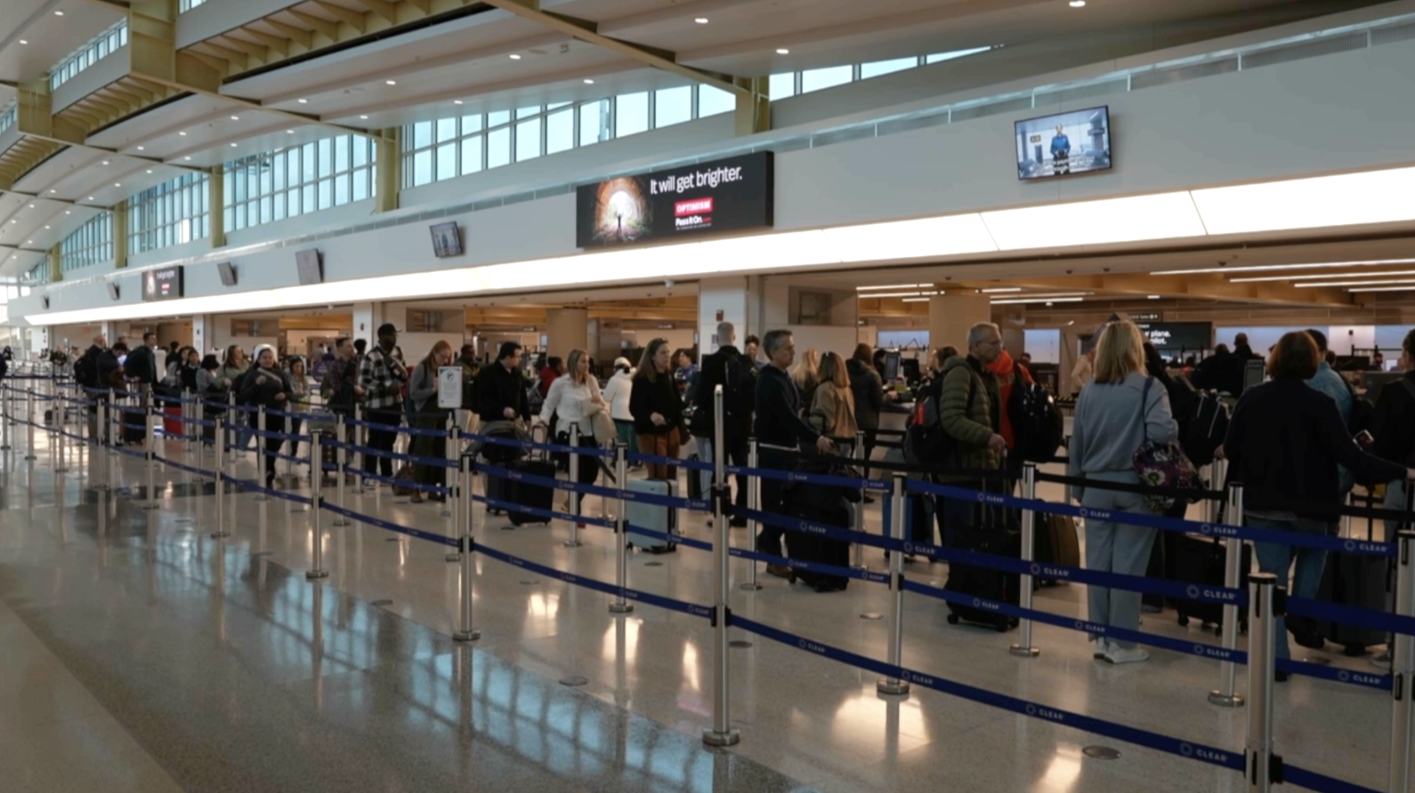 People standing in line at a U.S. airport. 