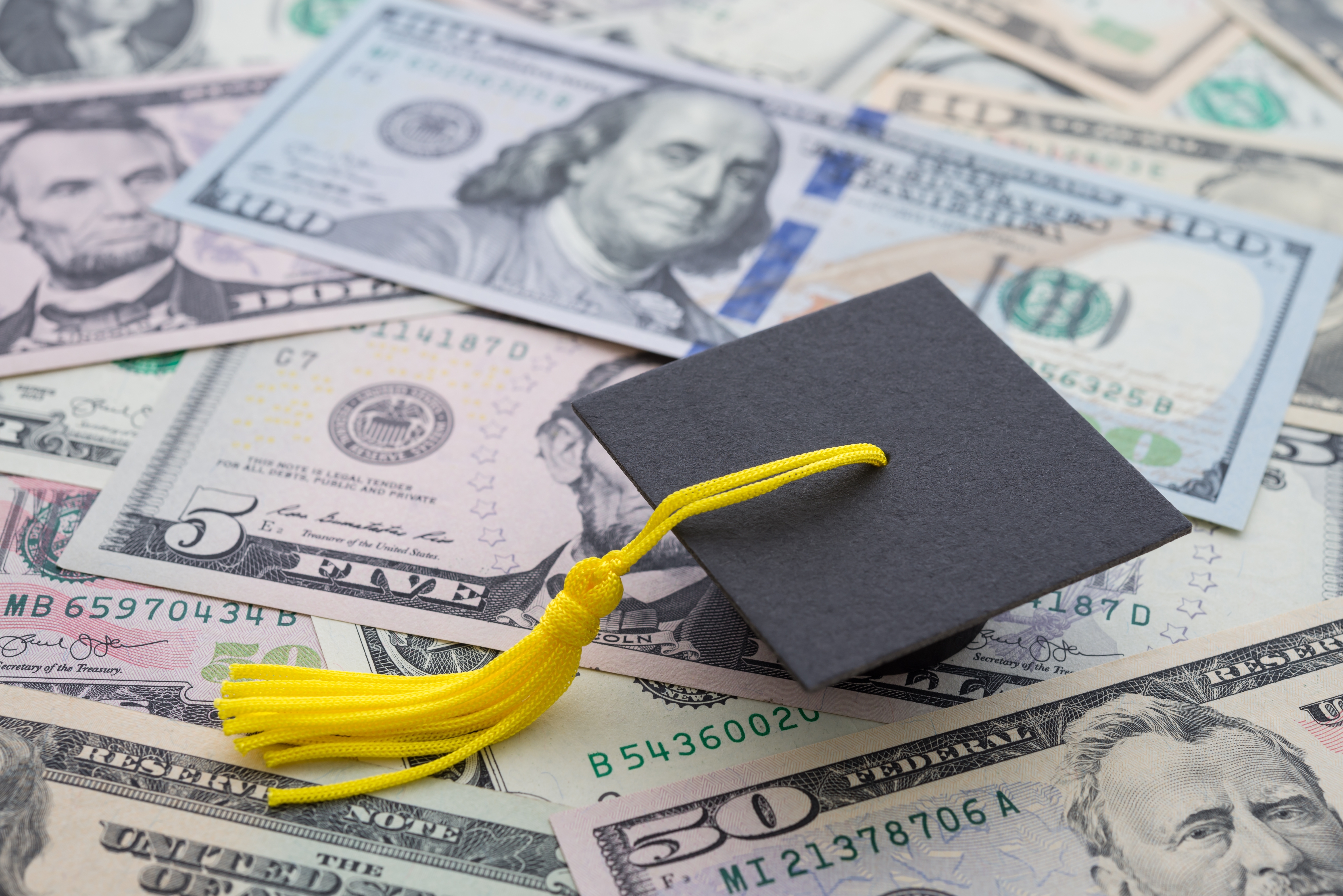 A graduation cap and money
