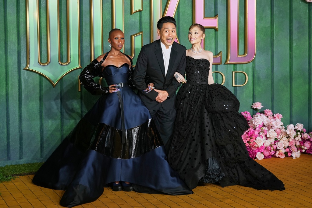 Cynthia Erivo, from left, director Jon M. Chu and Ariana Grande pose for photographers upon arrival at the premiere of the film "Wicked For Good" in London.