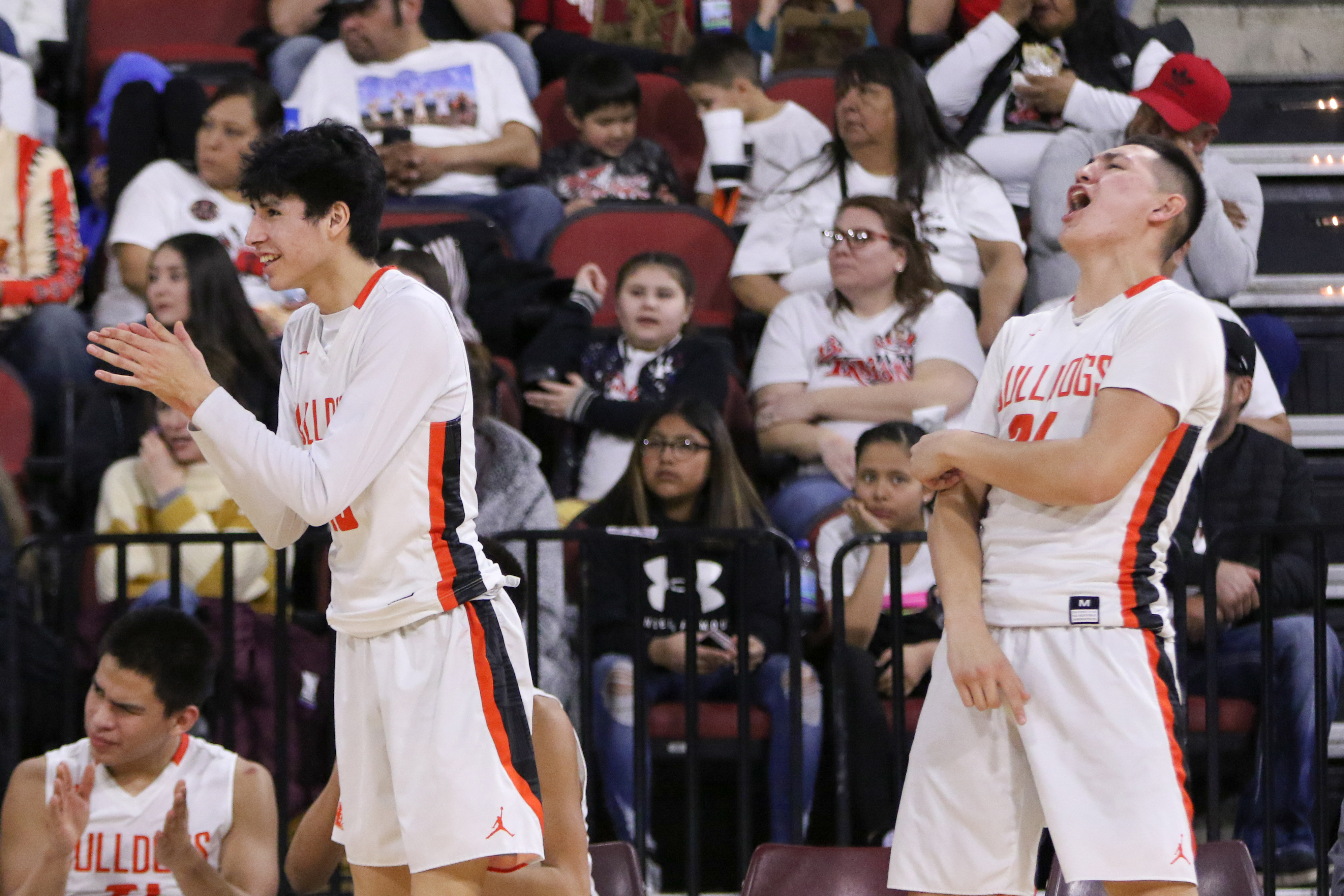 Trae Hugs and Cayden Redfield celebrate a charge taken by a teammate.jpg