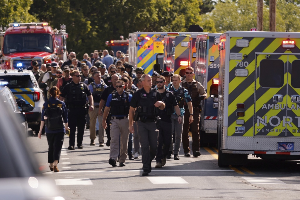 Law enforcement officers gather outside the Annunciation Church's school in response to a reported mass shooting, Wednesday, Aug. 27, 2025, in Minneapolis. 