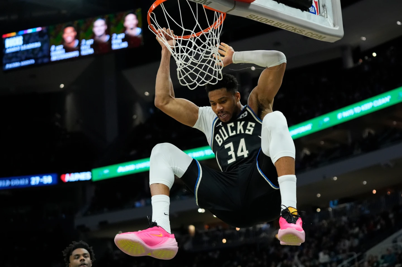 Milwaukee Bucks' Giannis Antetokounmpo hangs on the rim after dunking during the second half of an NBA basketball game against the Indiana Pacers, Sunday, March 15, 2026, in Milwaukee.