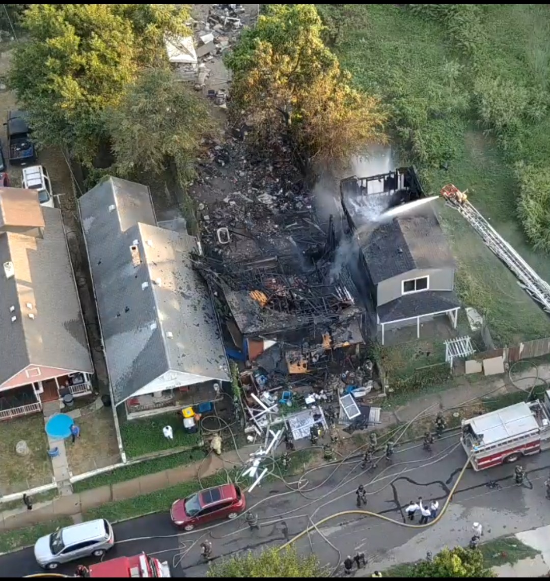 KCMO firefighters battle fire in 2 houses Thursday evening