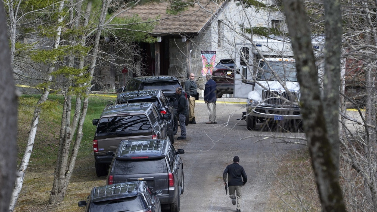 Investigators work at the scene of a deadly shooting.
