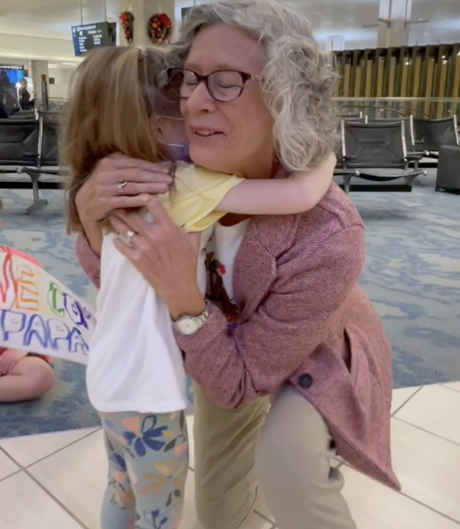 A grandma hugs her granddaughter at Tampa International Airport the day before Thanksgiving.