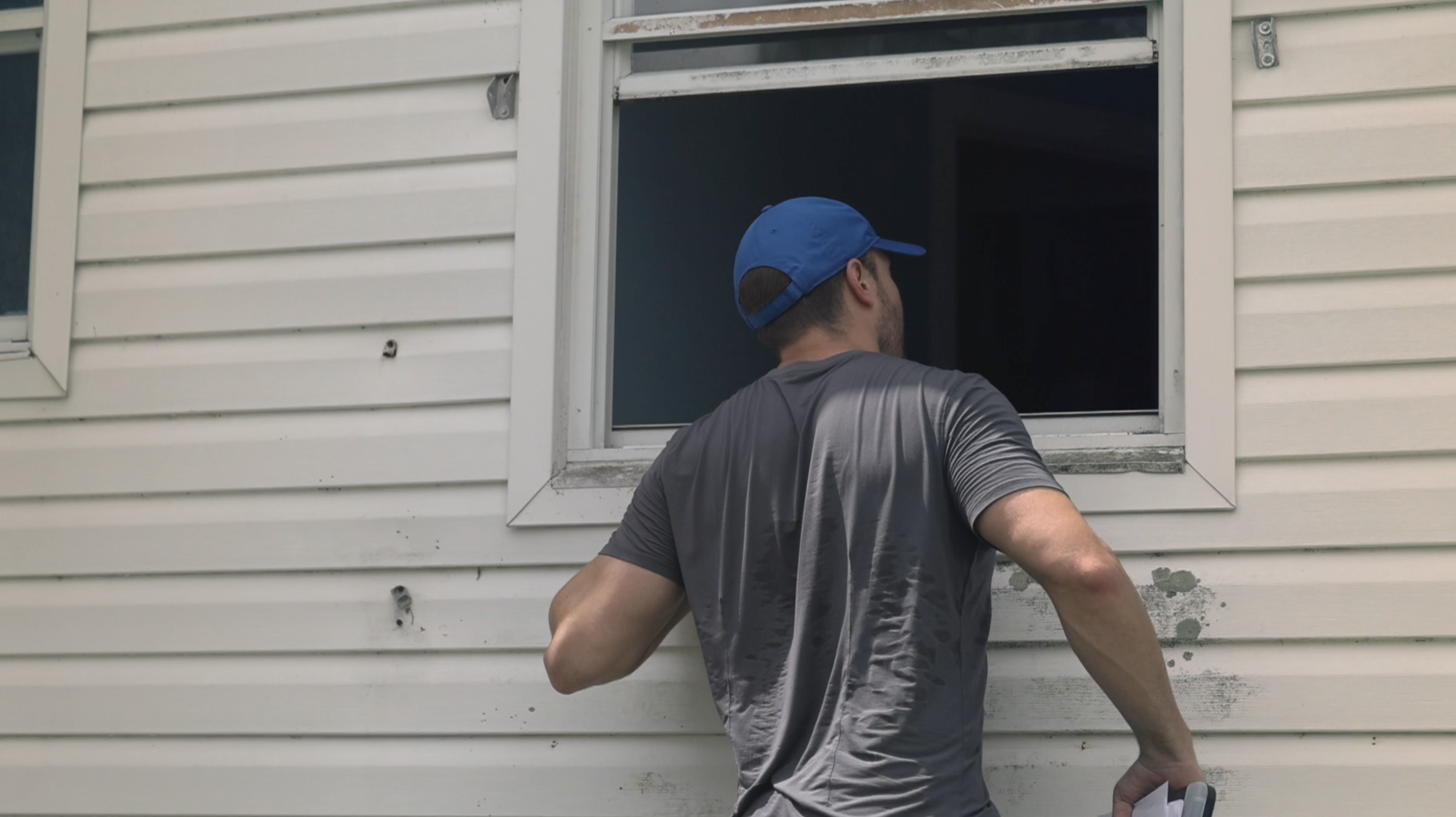 Alex Jandick looks for suspected squatters inside a home in St. Petersburg, Florida.