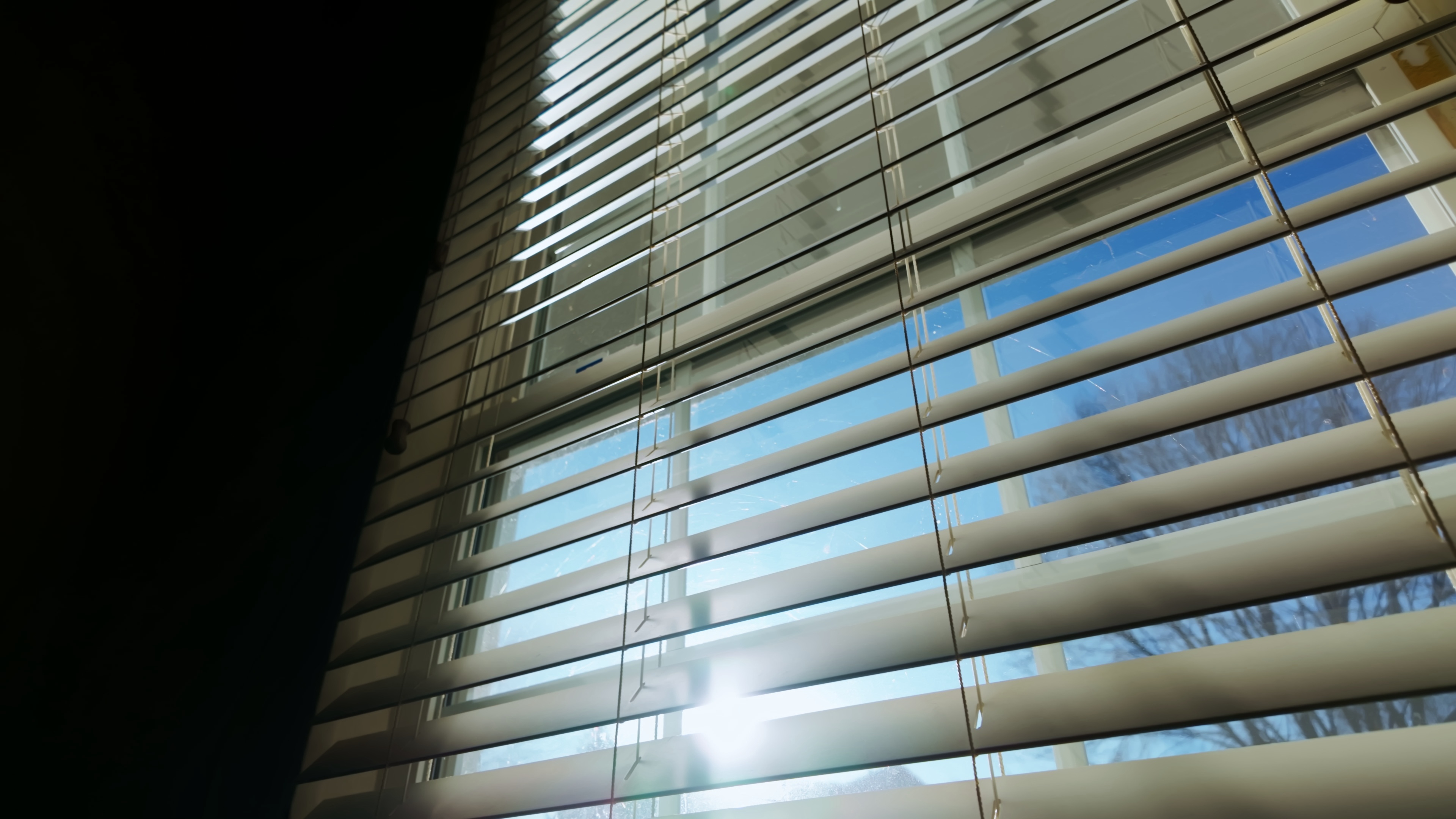 sun-shining-through-window-blinds-close-close-up-move-shot-SBI-349592912.jpg