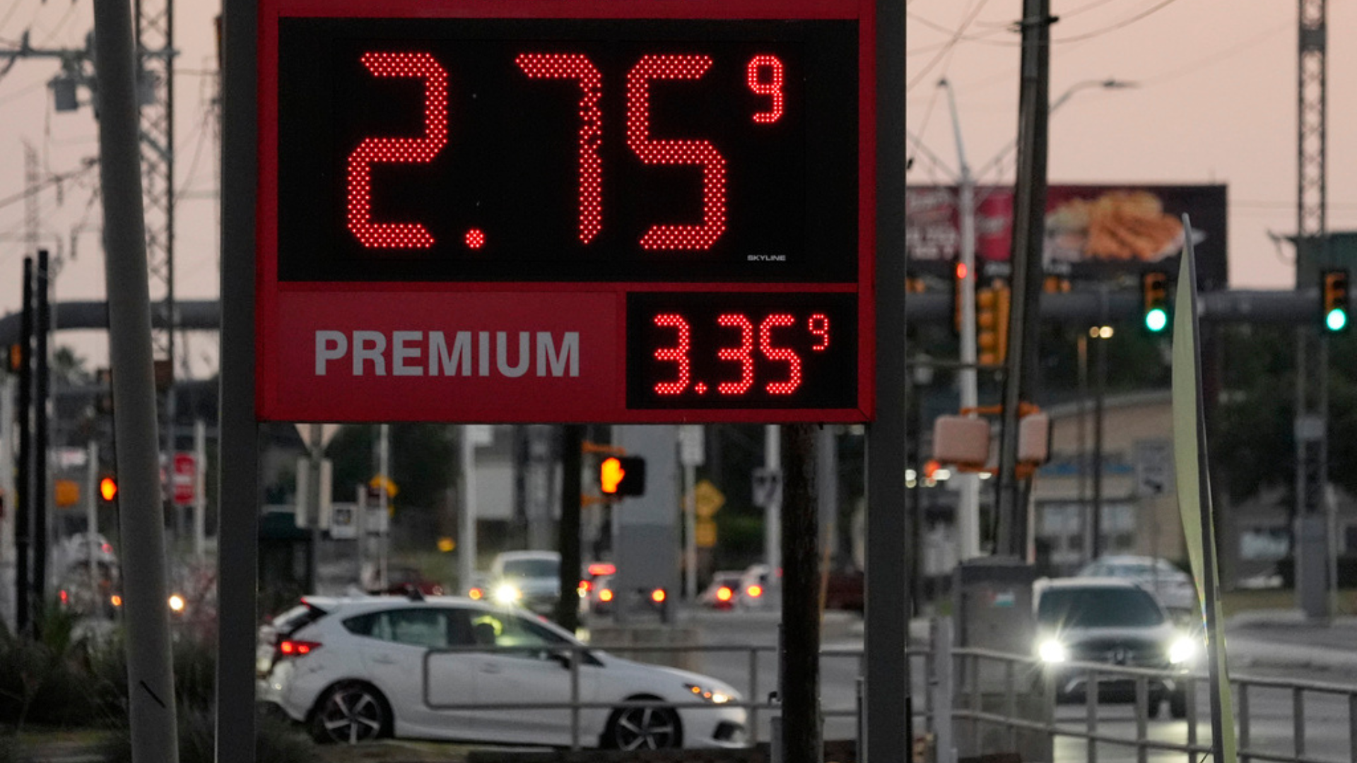 Motorist pass posted gas prices.