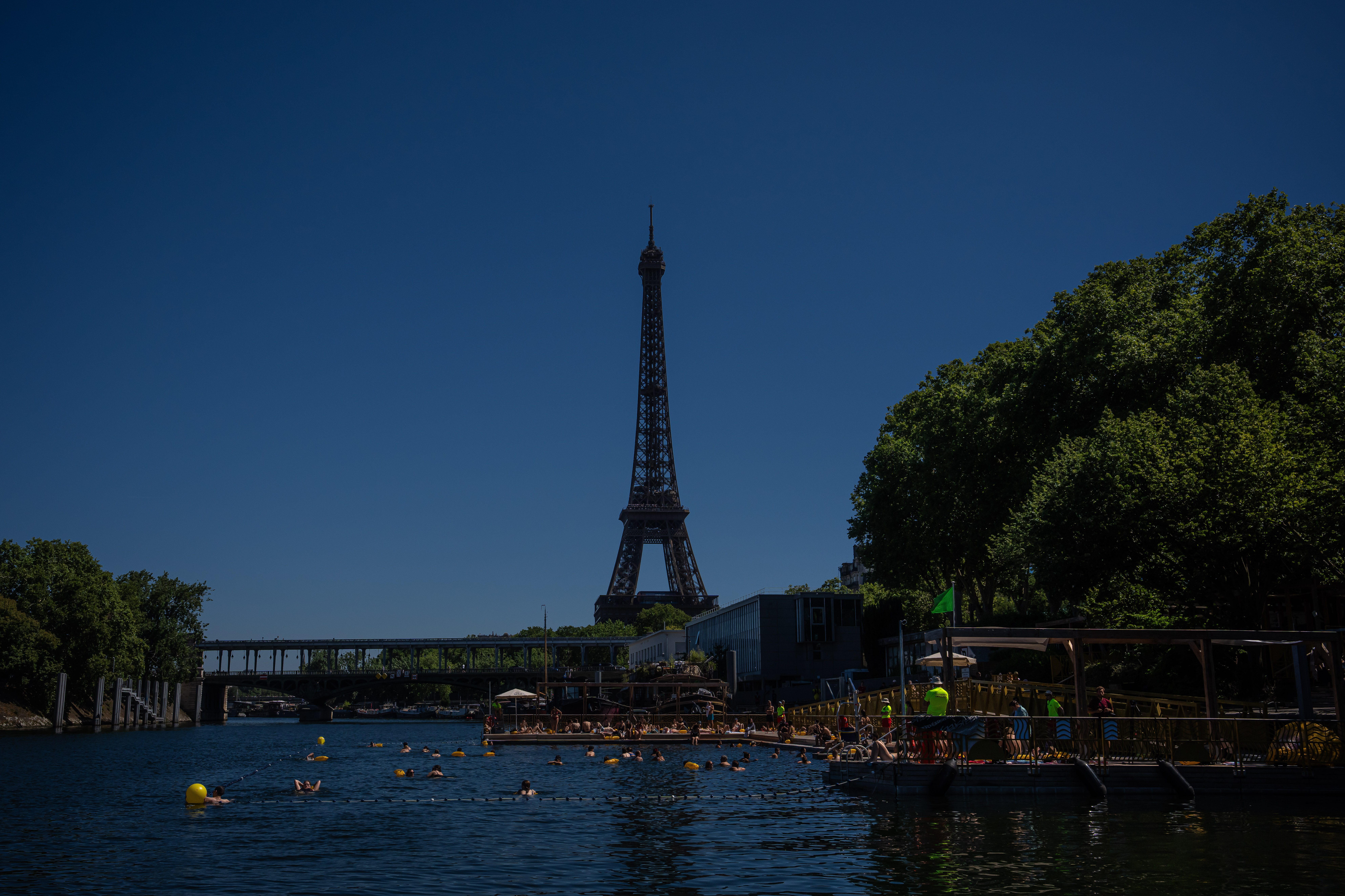 People swim in the Seine River, Saturday, July 4, 2026 in Paris.