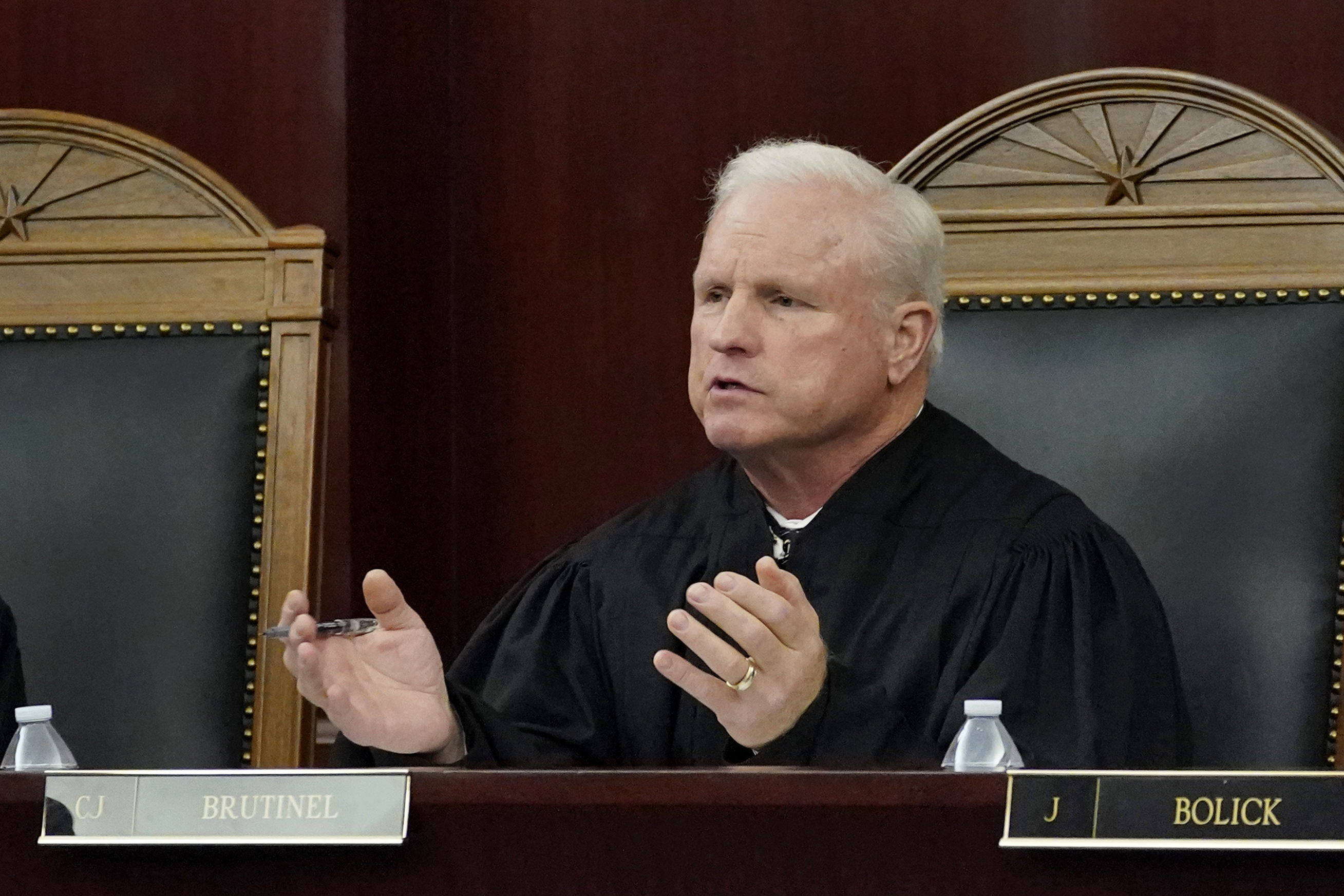 FILE - In this April 20, 2021, file photo, Arizona Supreme Court Chief Justice Robert M. Brutinel speaks during oral arguments, in Phoenix. The Arizona Supreme Court on Friday, Feb. 25, 2022, rejected a request from Republican lawmakers who asked it to bypass a lower court judge and immediately rule that a tax on the wealthy to fund education approved by the state's voters in 2020 can't be enforced."The superior court is within its jurisdiction, and this Court cannot at this time conclude that it can or should compel the superior court to act in a more expeditious manner," Chief Justice Brutinel wrote. (AP Photo/Matt York, File)

