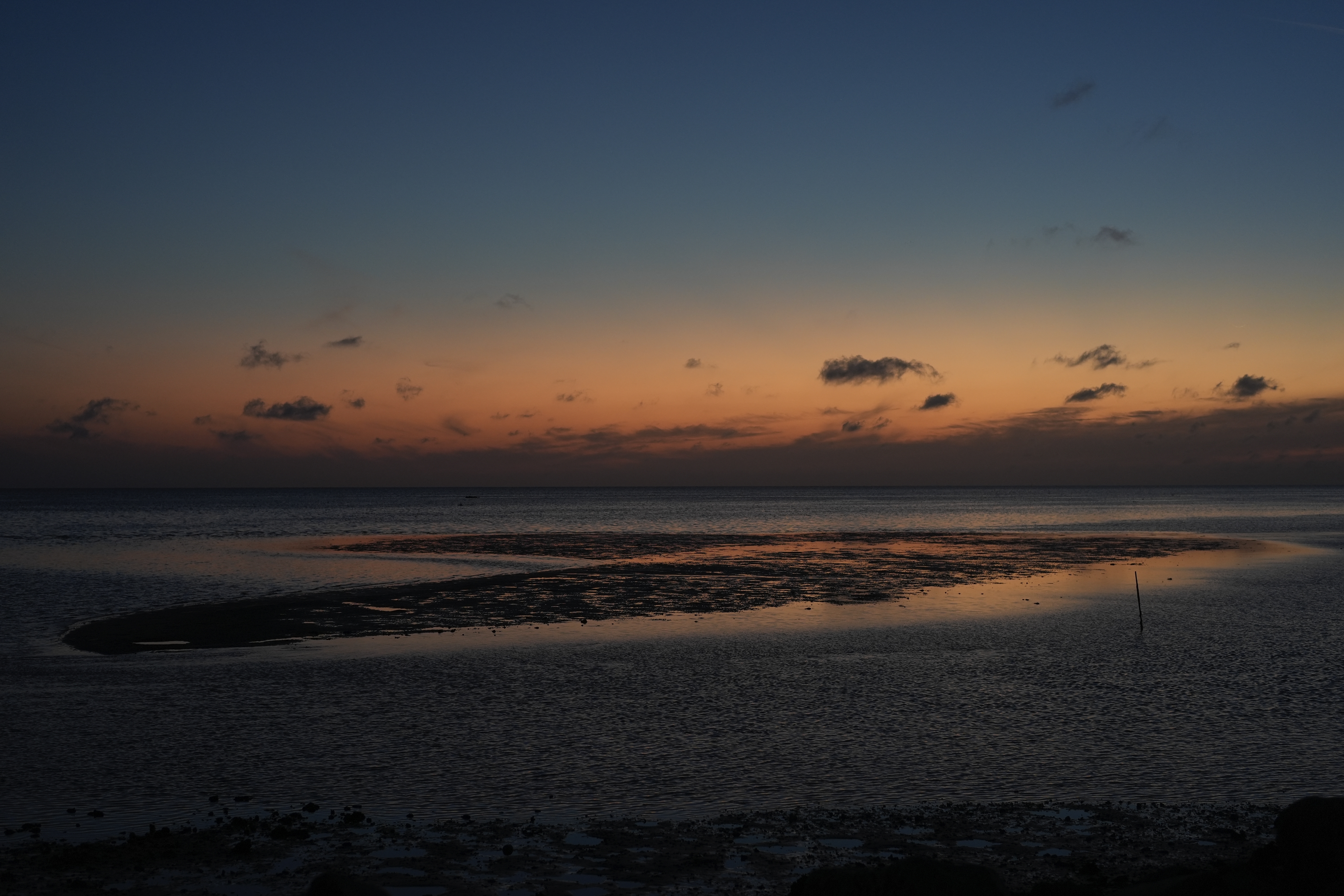 FILE: A sunset sky reflects off of water surrounding a sandbar just off the coast of Horseshoe Beach, Fla., Wednesday, May 8, 2024. 