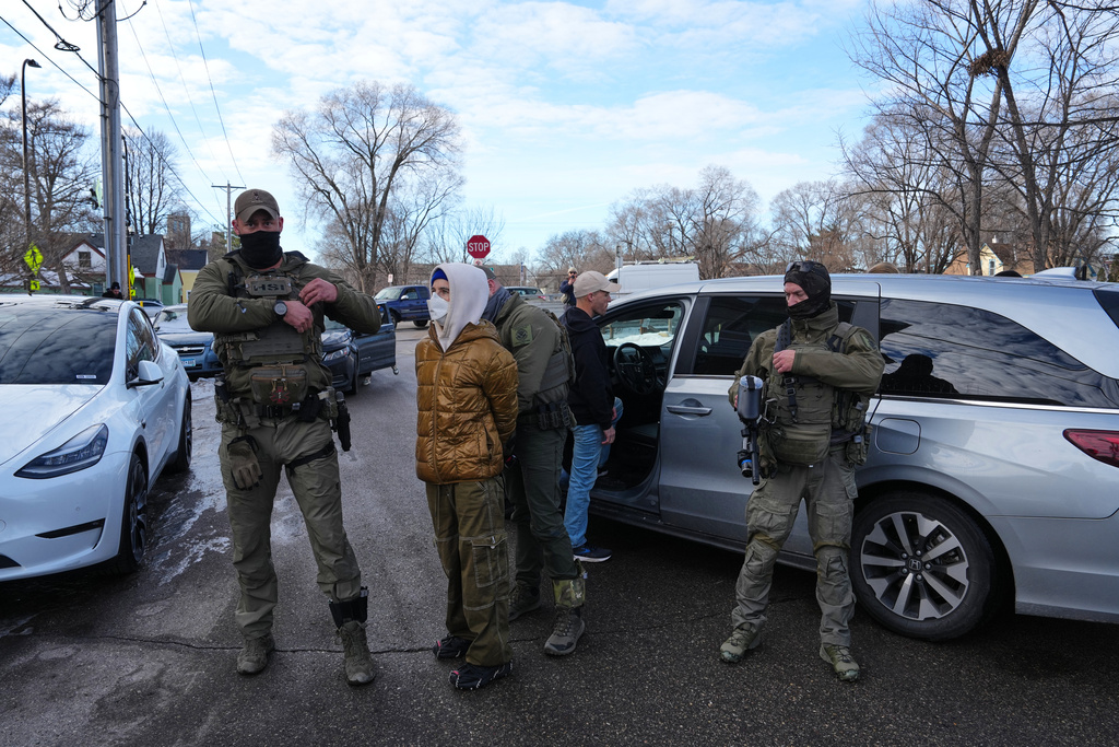 A protester is detained by federal immigration officers before being let go Monday, Jan. 12, 2026, in Minneapolis. 