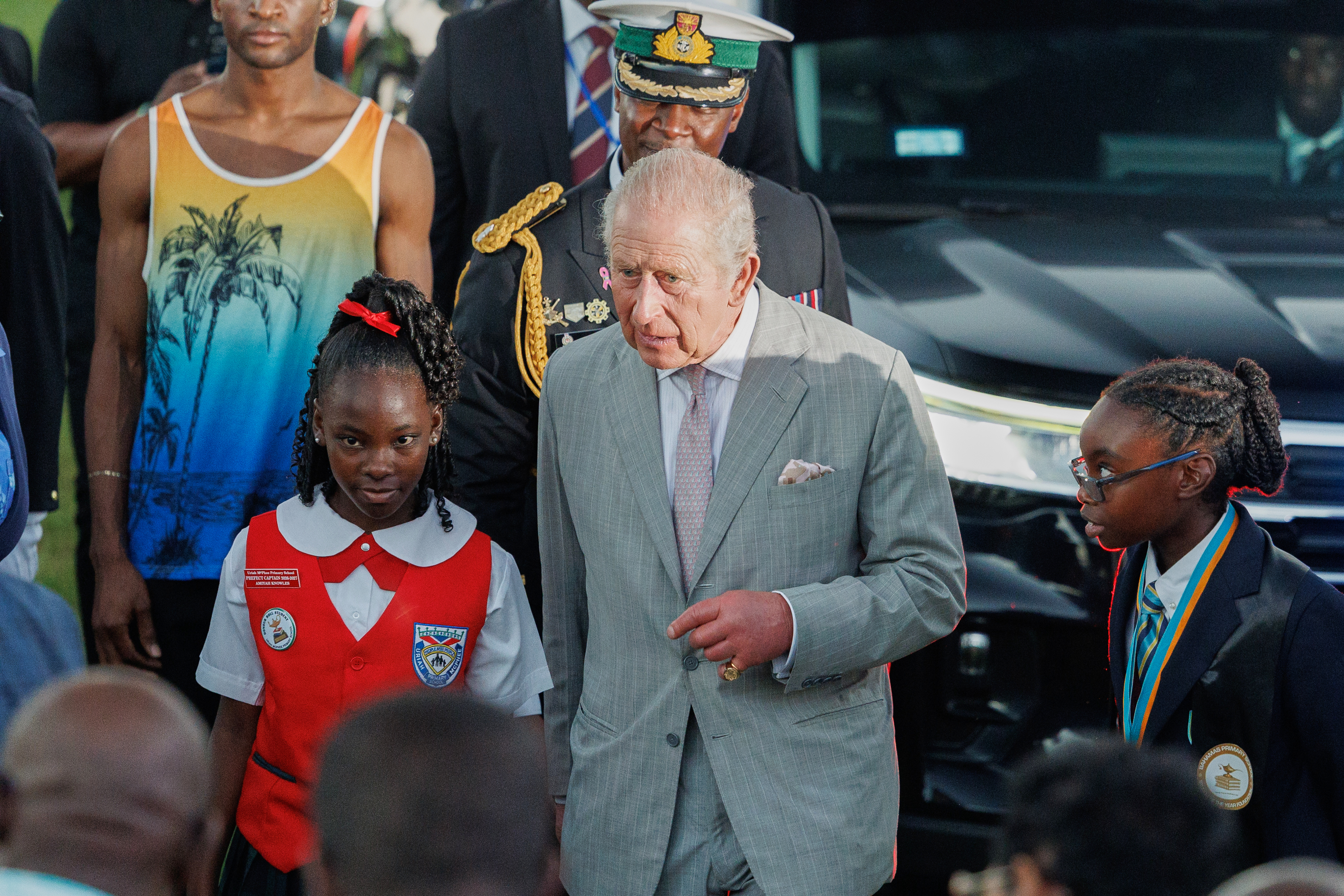 Britain's King Charles III is escorted by students as he leaves The Future Bahamas Youth Rally and Exhibition at Clifford Park in Nassau, Bahamas, Tuesday, Oct. 27, 2026.