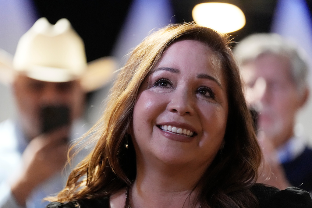 Adelita Grijalva listens to her children speak at the stage podium after being declared the winner against Republican Daniel Butierez, to fill the Congressional District 7 seat held by the late Rep. Raúl Grijalva in a special election Sept. 23, 2025, in Tucson, Ariz.
