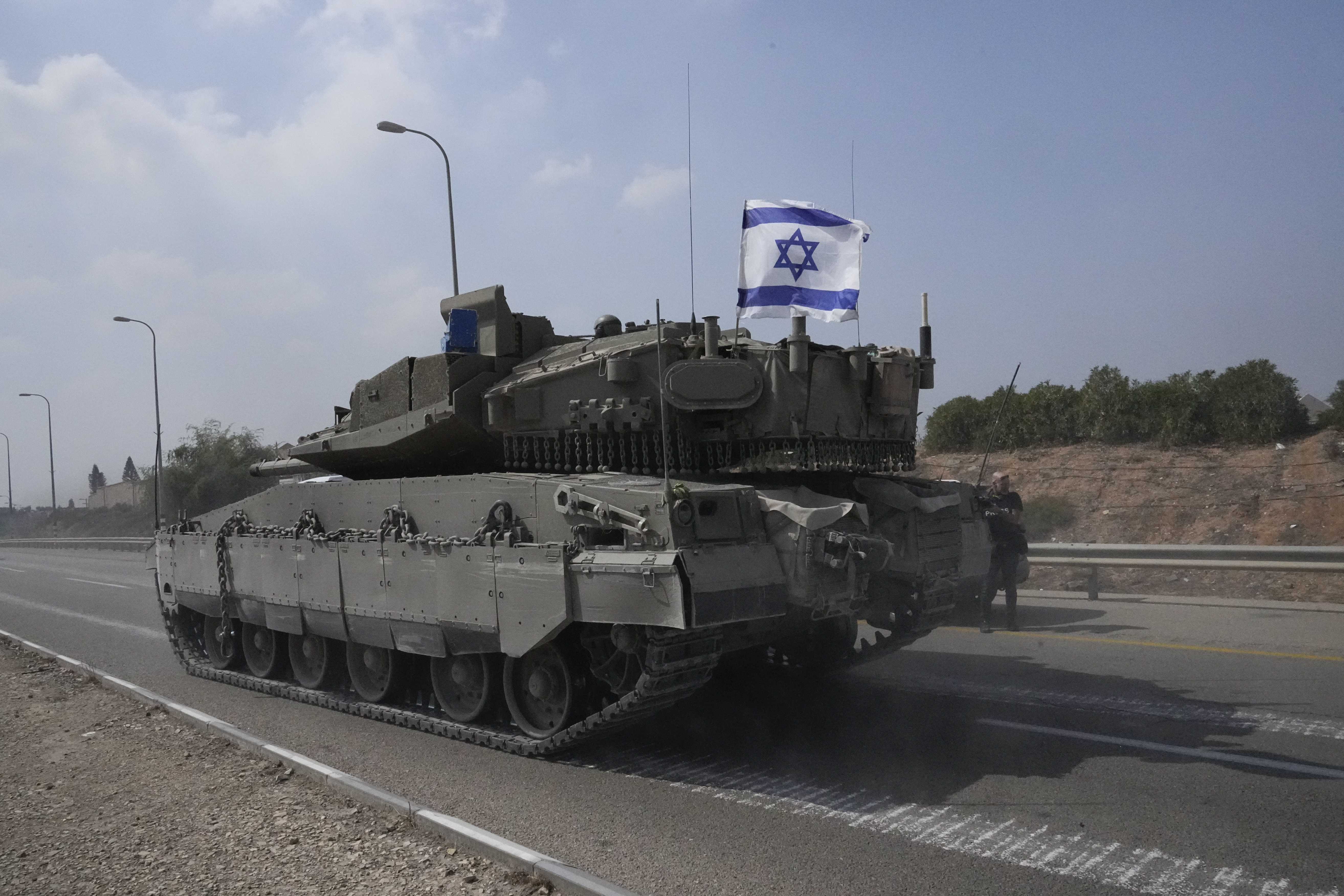 Israeli tank heads south near Sderot, Israel, Sunday, Oct.8, 2023. Hamas militants stormed over the border fence Saturday, killing hundreds of Israelis in surrounding communities. (AP Photo/Ohad Zwigenberg)