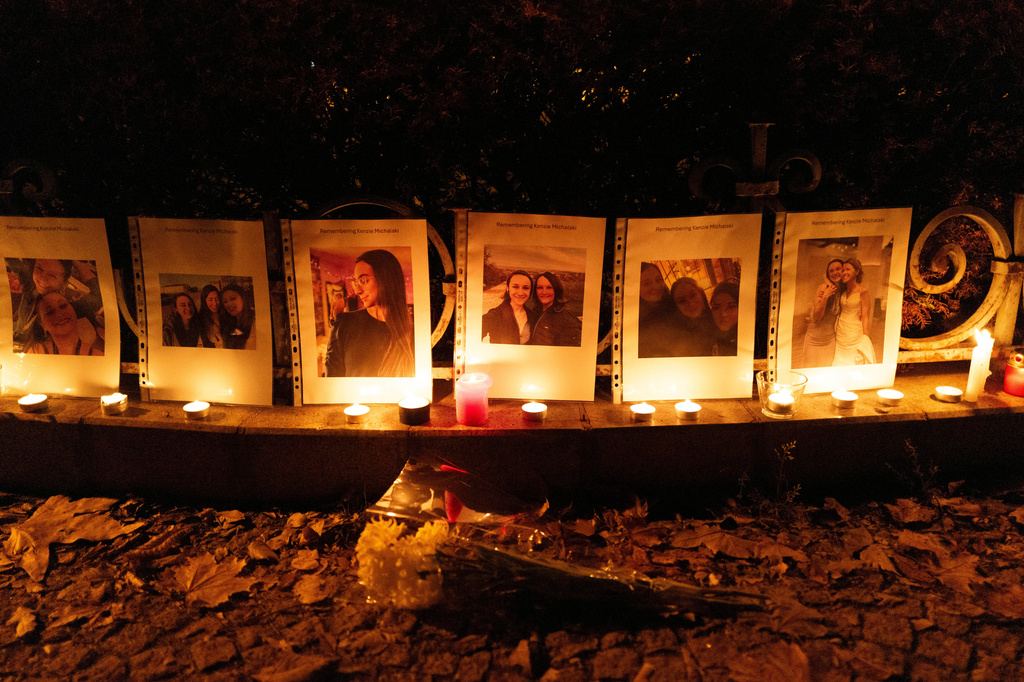 Photos showing Mackenzie Michalski, a 31-year-old American tourist who was murdered while on vacation, hang at a candlelight vigil in Budapest, Hungary, on Nov. 9, 2024. 