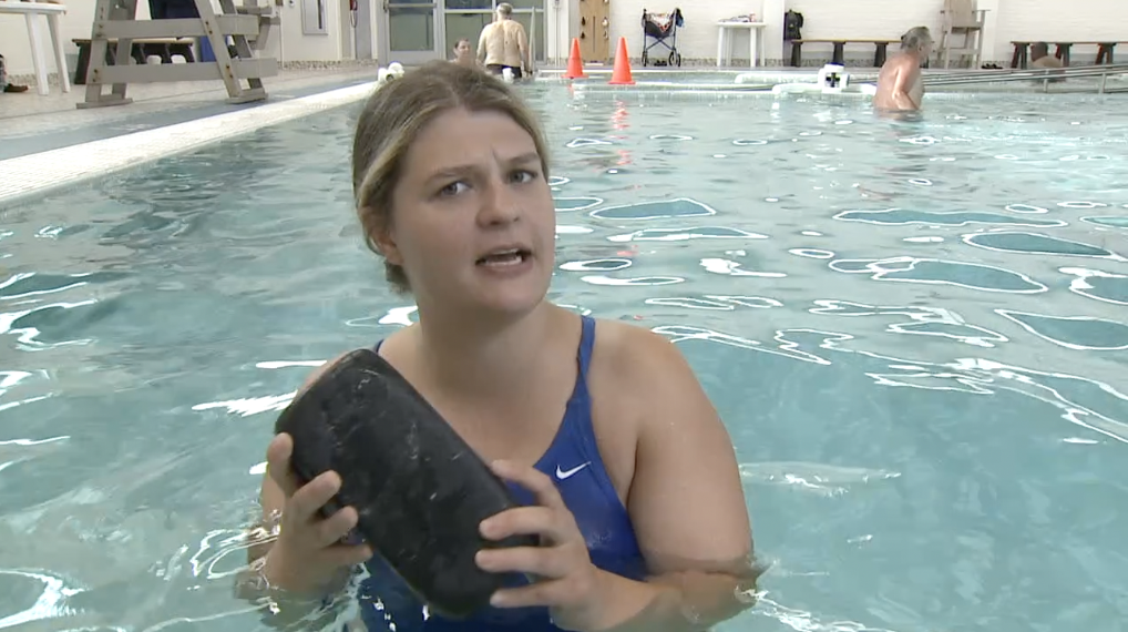 julie in the pool with a brick.png
