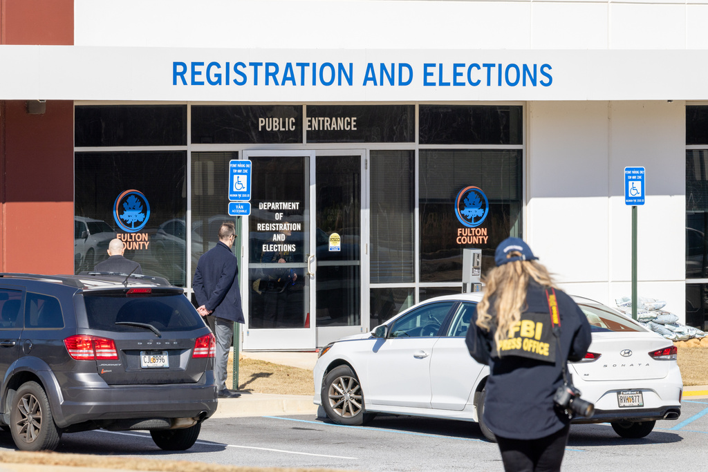 An FBI press office person approaches the Fulton County Election Hub and Operation Center.