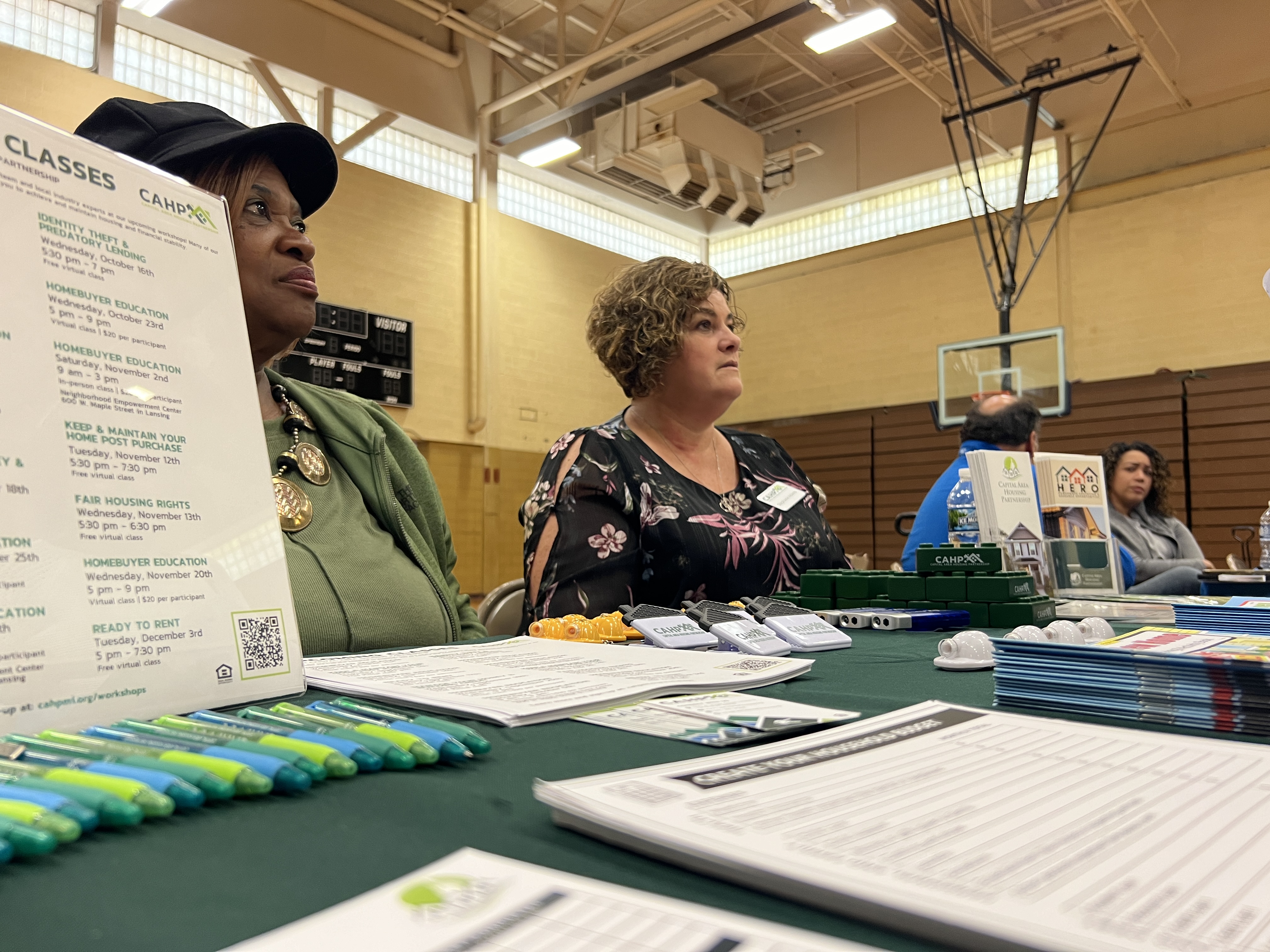 Representatives of community organizations speak with Lansing residents to provide financial assistance and other resources. 