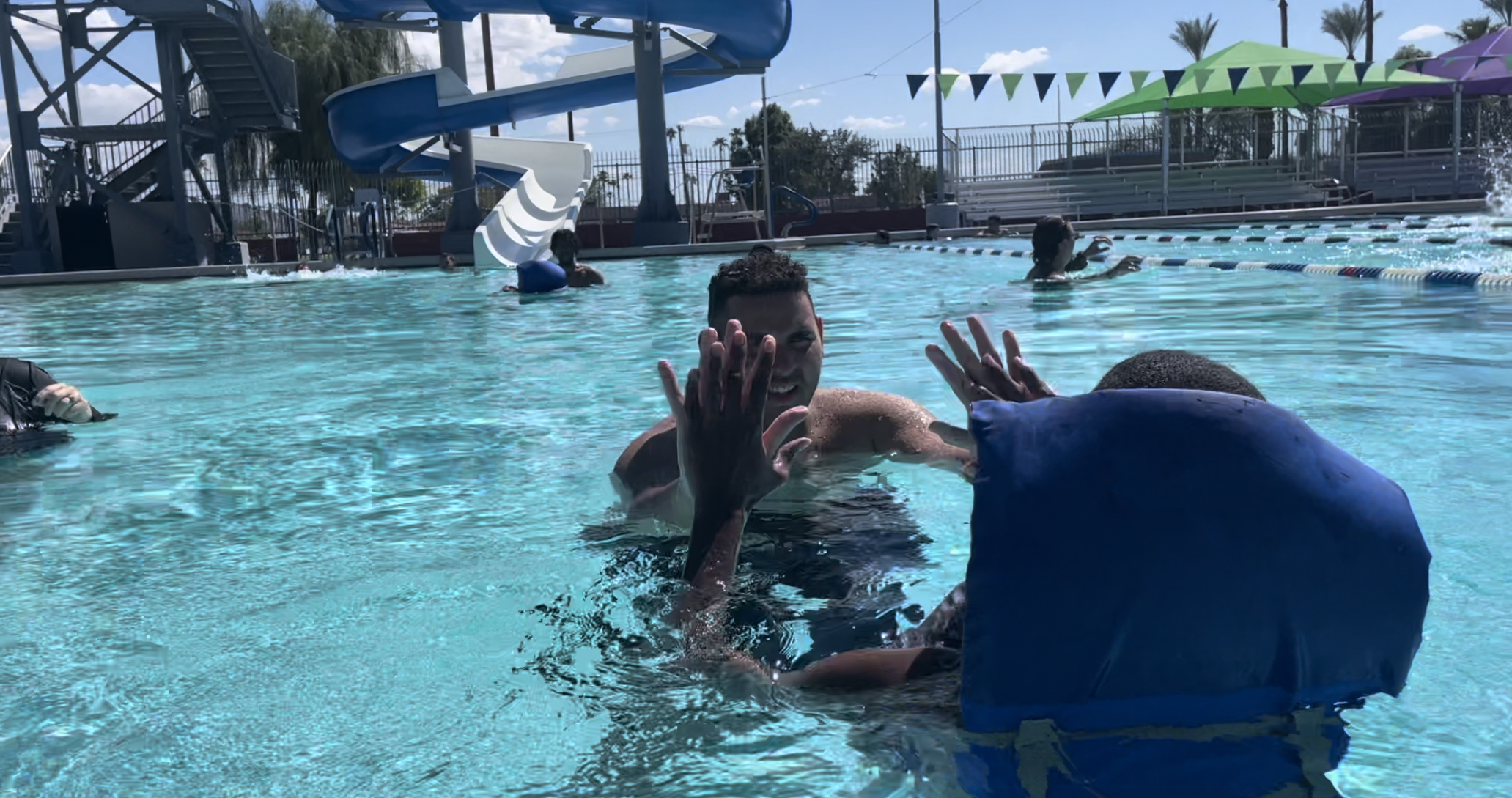 Buckeye Union High student teaches another to swim in Unified Sports team.jpg