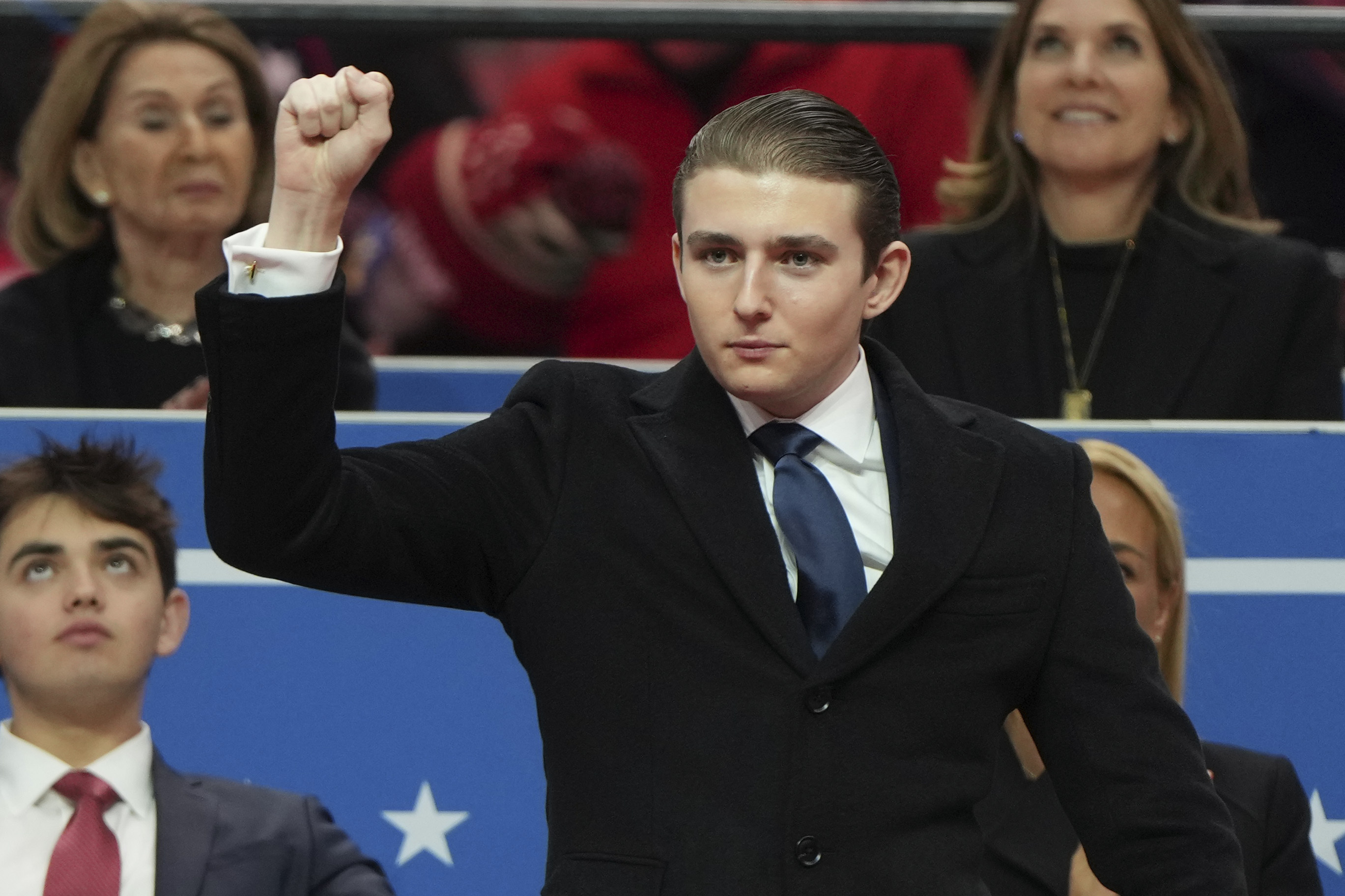 Barron Trump gestures at an indoor Presidential Inauguration parade event in Washington, Monday, Jan. 20, 2025. 