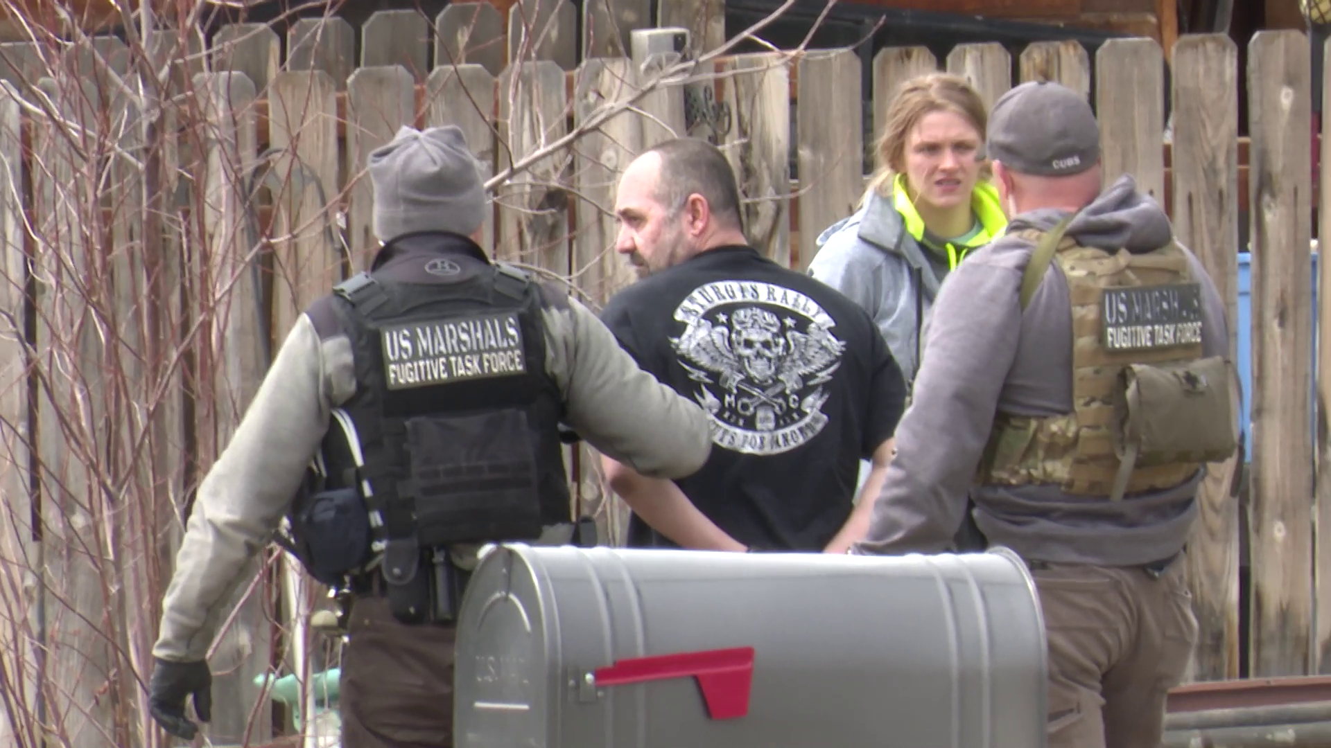 U.S. Marshals with the Fugitive Task Force escorted a man in handcuffs out of the house.