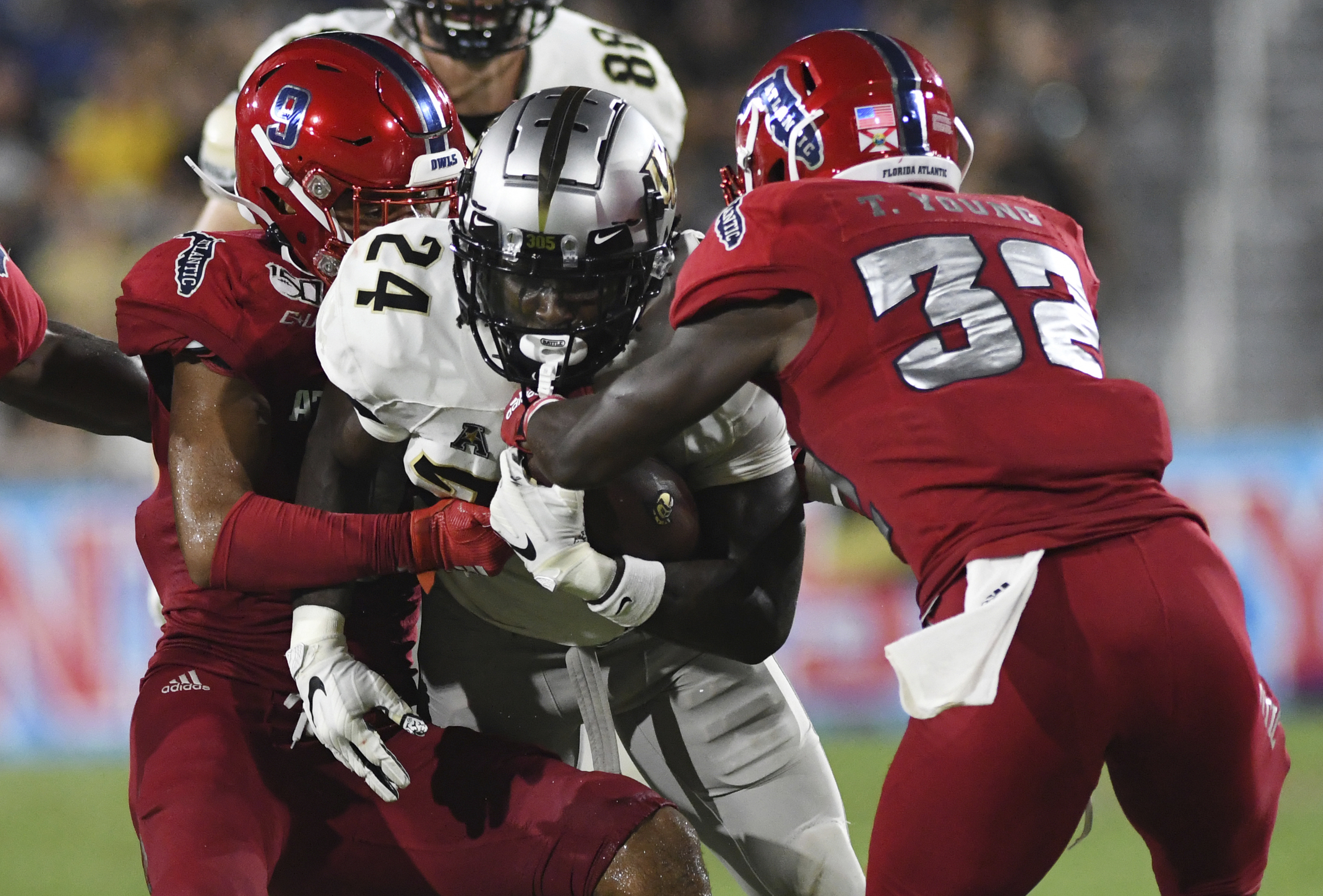 FAU Owls safety Quran Hafiz tackles UCF Knights Bentavious Thompson in 2019