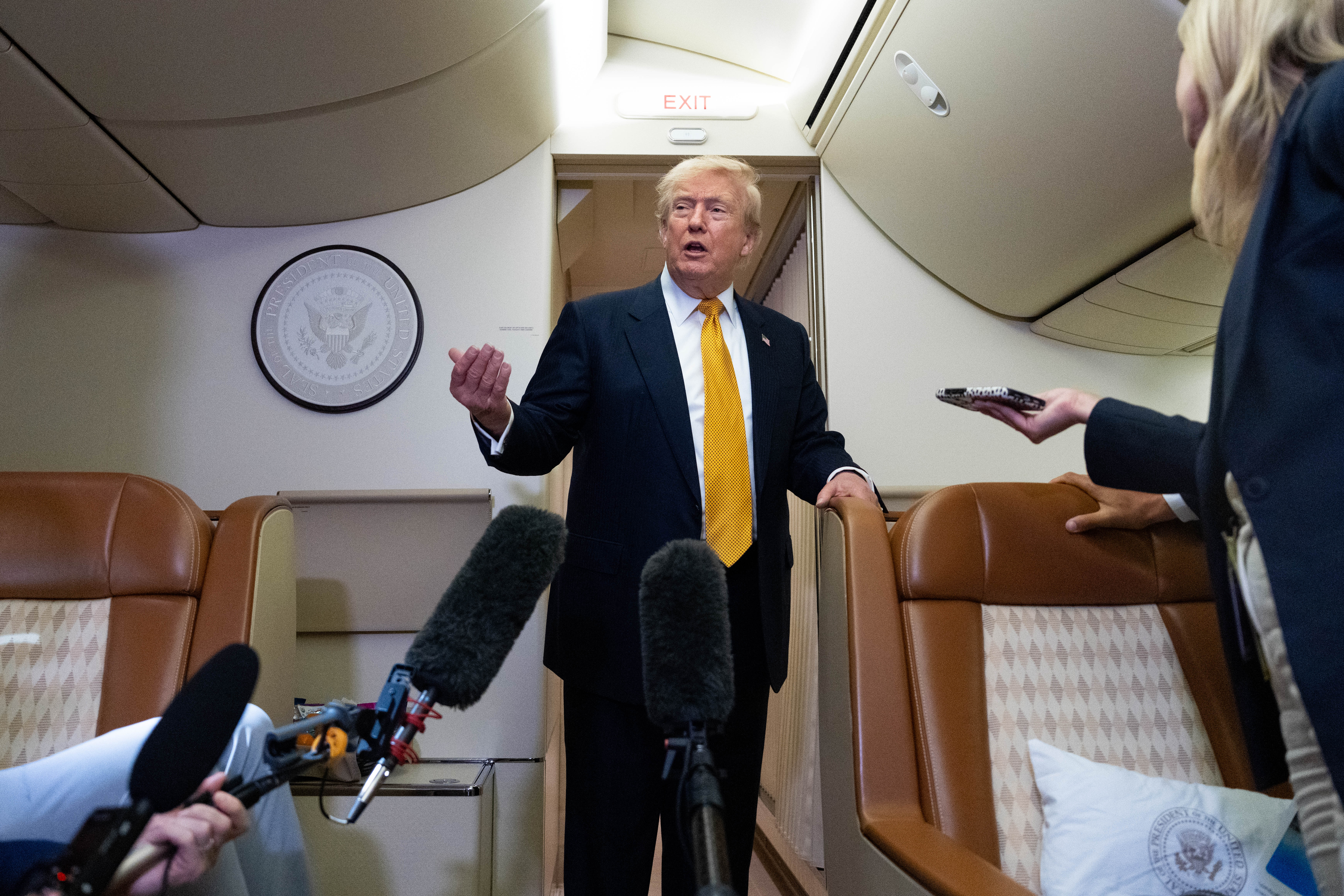 President Donald Trump speaks with reporters in flight on Air Force One after landing at U.S. Air Force Base at RAF Mildenhall, in Suffolk, Eastern England, Wednesday, July 8, 2026. 