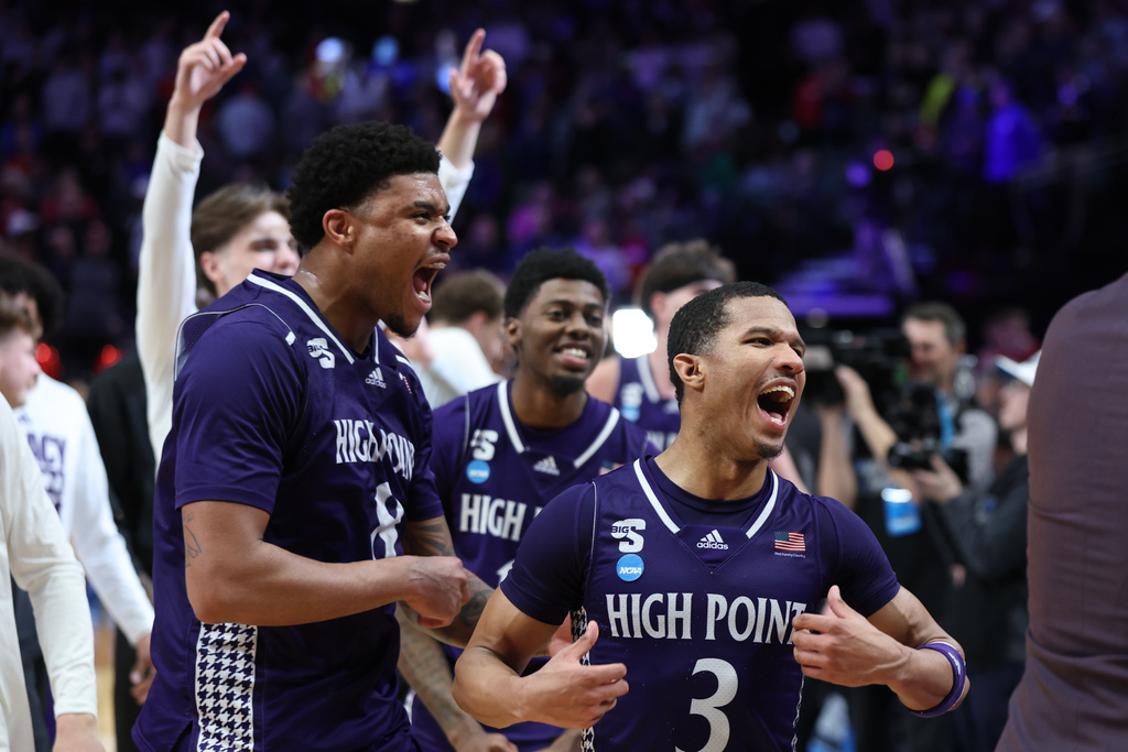 High Point guard Rob Martin (3) celebrates with forward Owen Aquino (8) after the first round of the NCAA college basketball tournament against Wisconsin, Thursday, March 19, 2026, in Portland, Ore. 