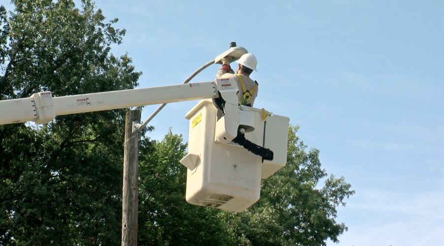 crews replacing streetlights