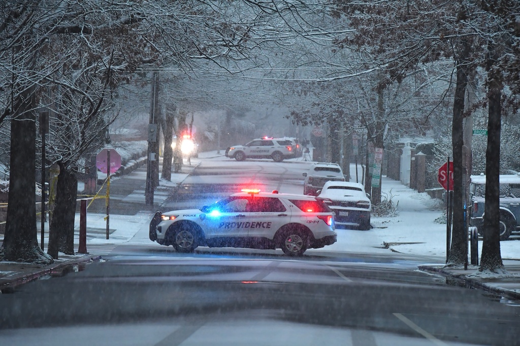 Police vehicles rest in intersections in a neighborhood near Brown University, Sunday, Dec. 14, 2025, in Providence, R.I., following a shooting at the university Saturday, Dec. 13. 