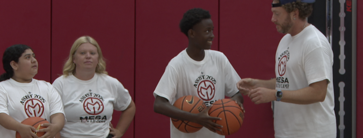 Rayvion Fields with his mentor at SDSU during a youth basketball camp. 