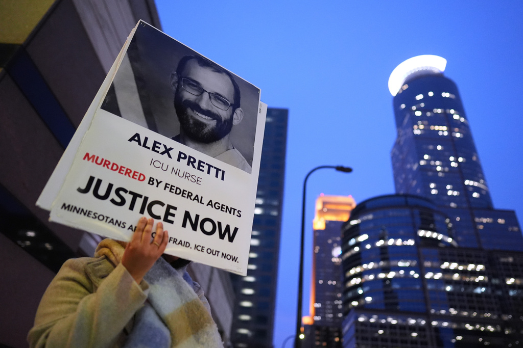 A person holds a sign of Alex Pretti during a protest outside the office of Sen. Amy Klobuchar, D-Minn., on Monday, Jan. 26, 2026, in Minneapolis.